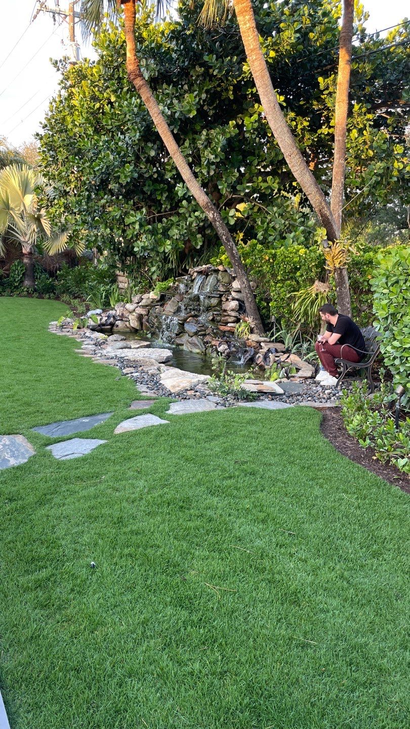 A Beautiful Relaxing Koi Pond with Waterfall in Pinecrest by Nature's Dream Landscape and Tree Service