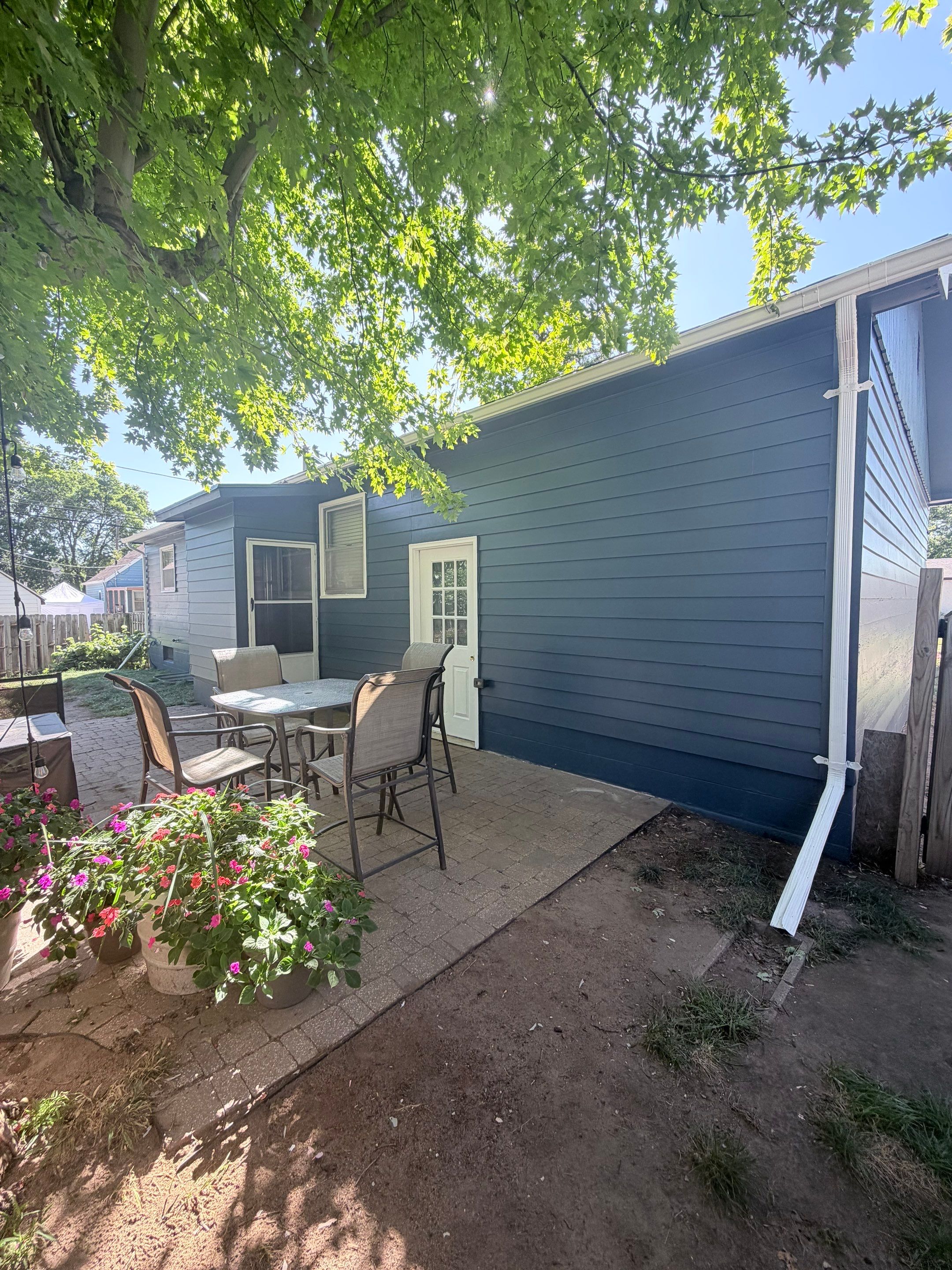 Dark Blue Exterior Painting and Trim Refresh in Sioux Falls by Select Painting, Coatings & Garage Cabinets