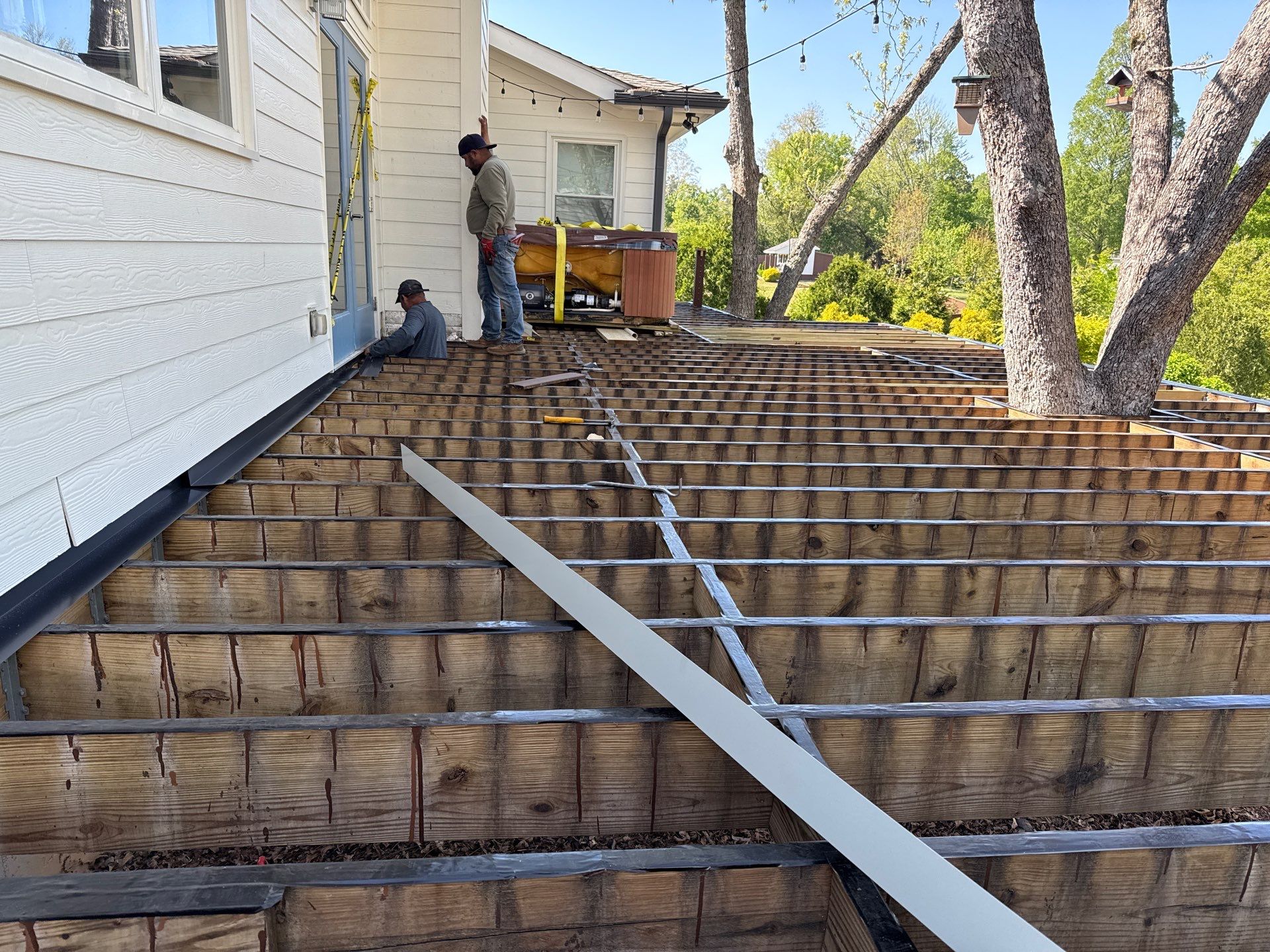 Deck Resurface with Glass Paneling and Deckorators Voyage Series Products by Nelson Exteriors 