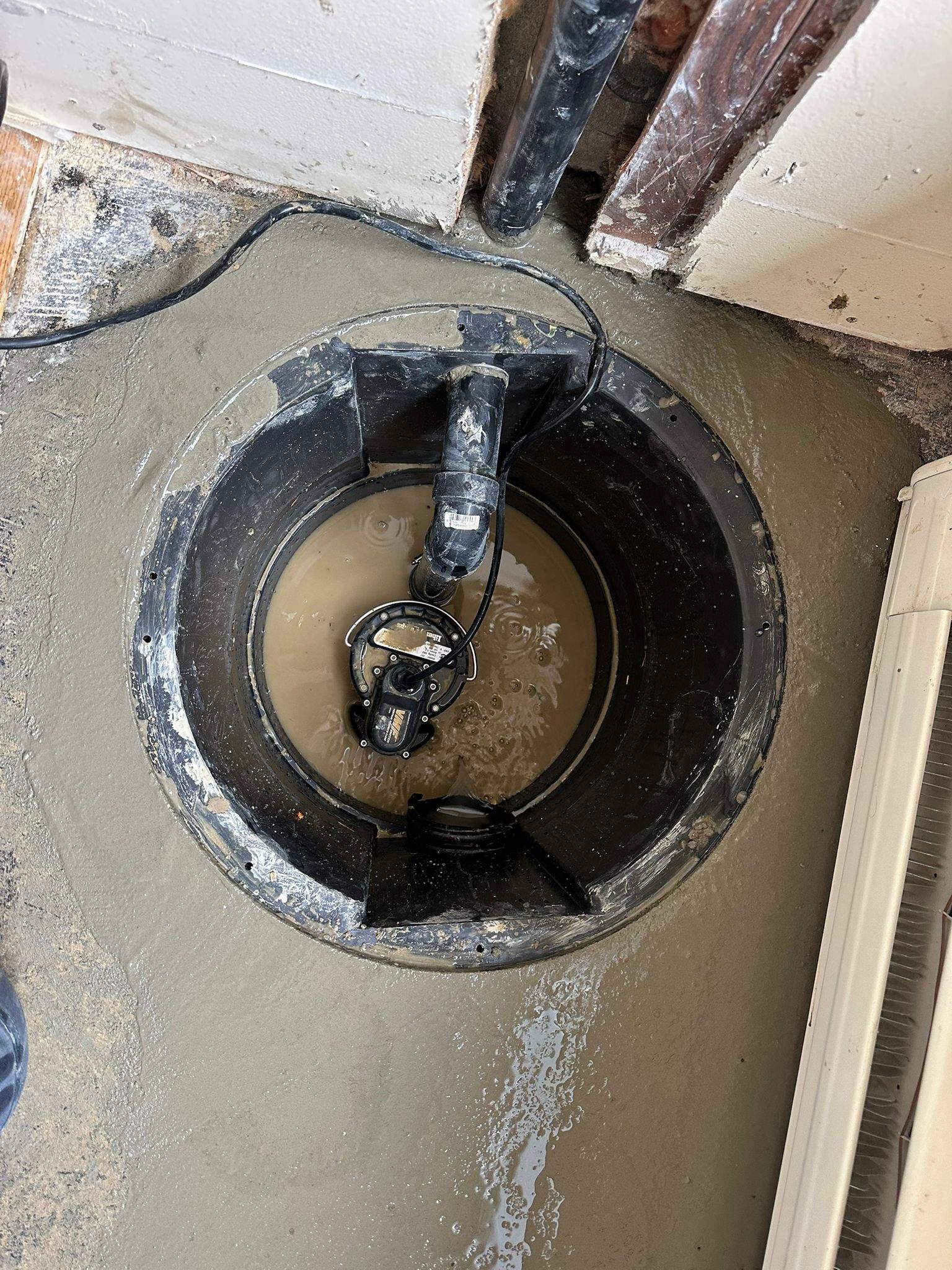 Sump Pump with catch basin install by Canada Waterproofers Inc