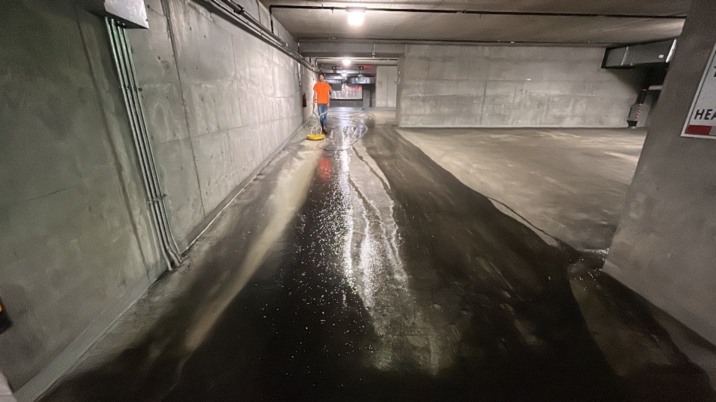 Parking garage using Hot water by Northern Power Washing LLC.