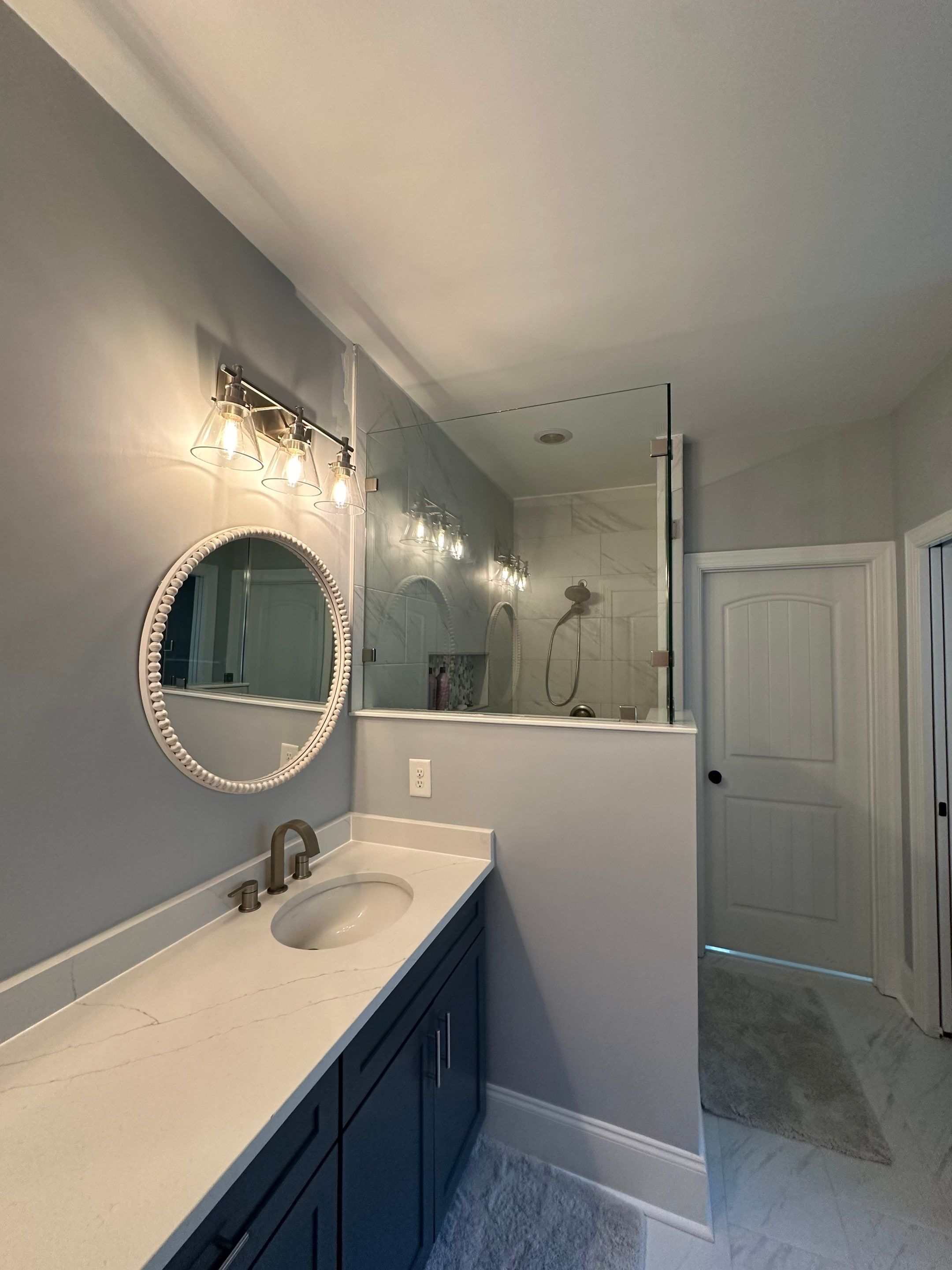 Bright Bathroom Remodel with Wall Removal, Stand Alone Tub and New Vanity by Footprints Floors of Coastal Carolina