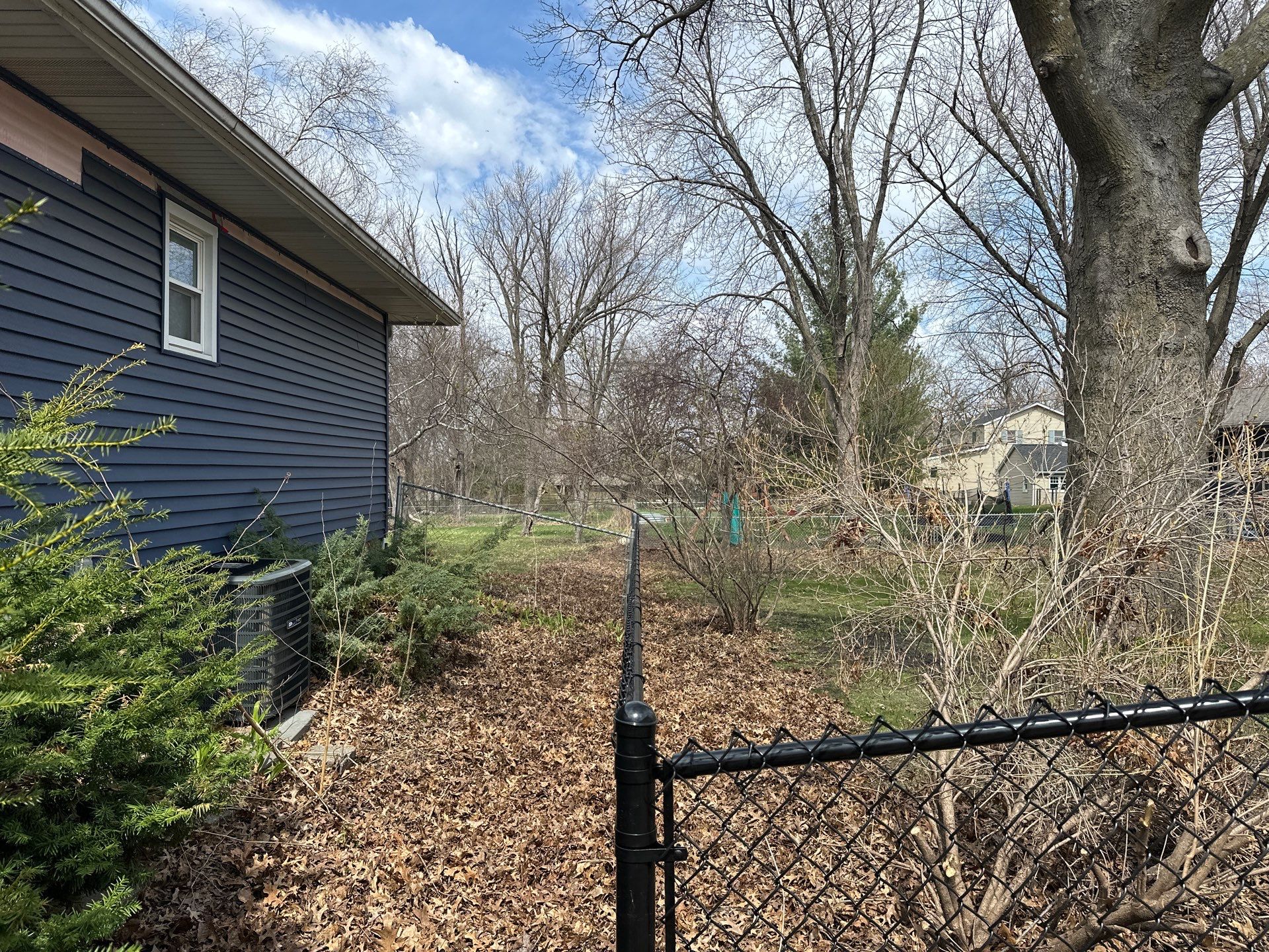 Black Vinyl-Coated Chain Link Fence Installation in Cedar Falls by Perfect Picket Fence and Stain