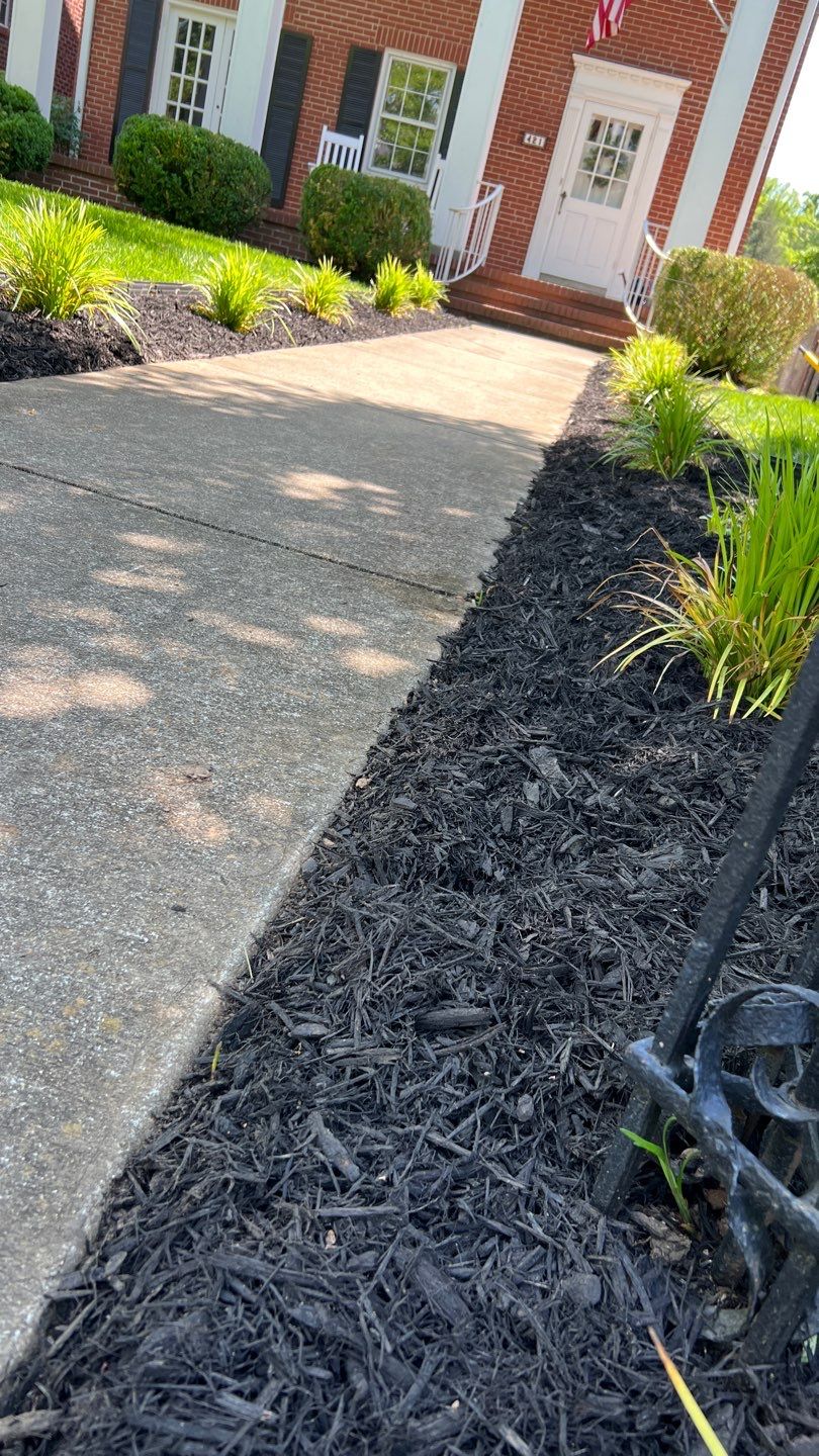 Liriope grasses, mulch and stone pavers by GrassBusters, Inc.