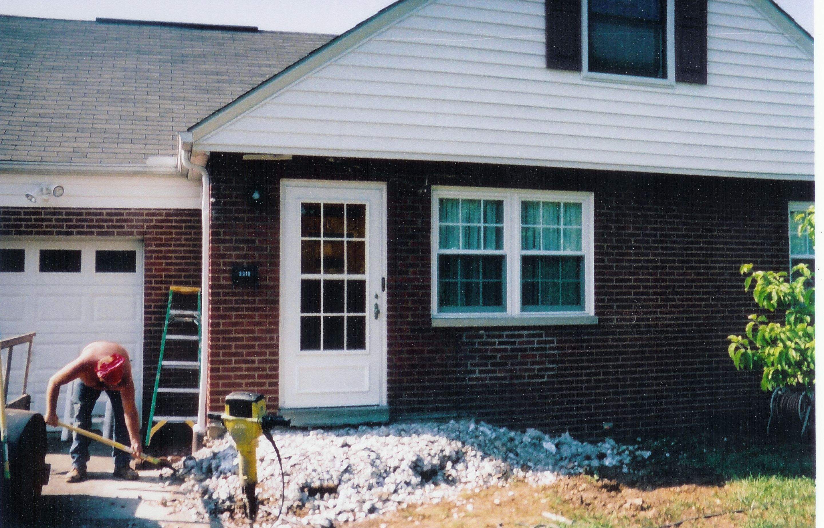 New front porch build, with tile floor and vinyl railing. by Secure Construction Company Inc