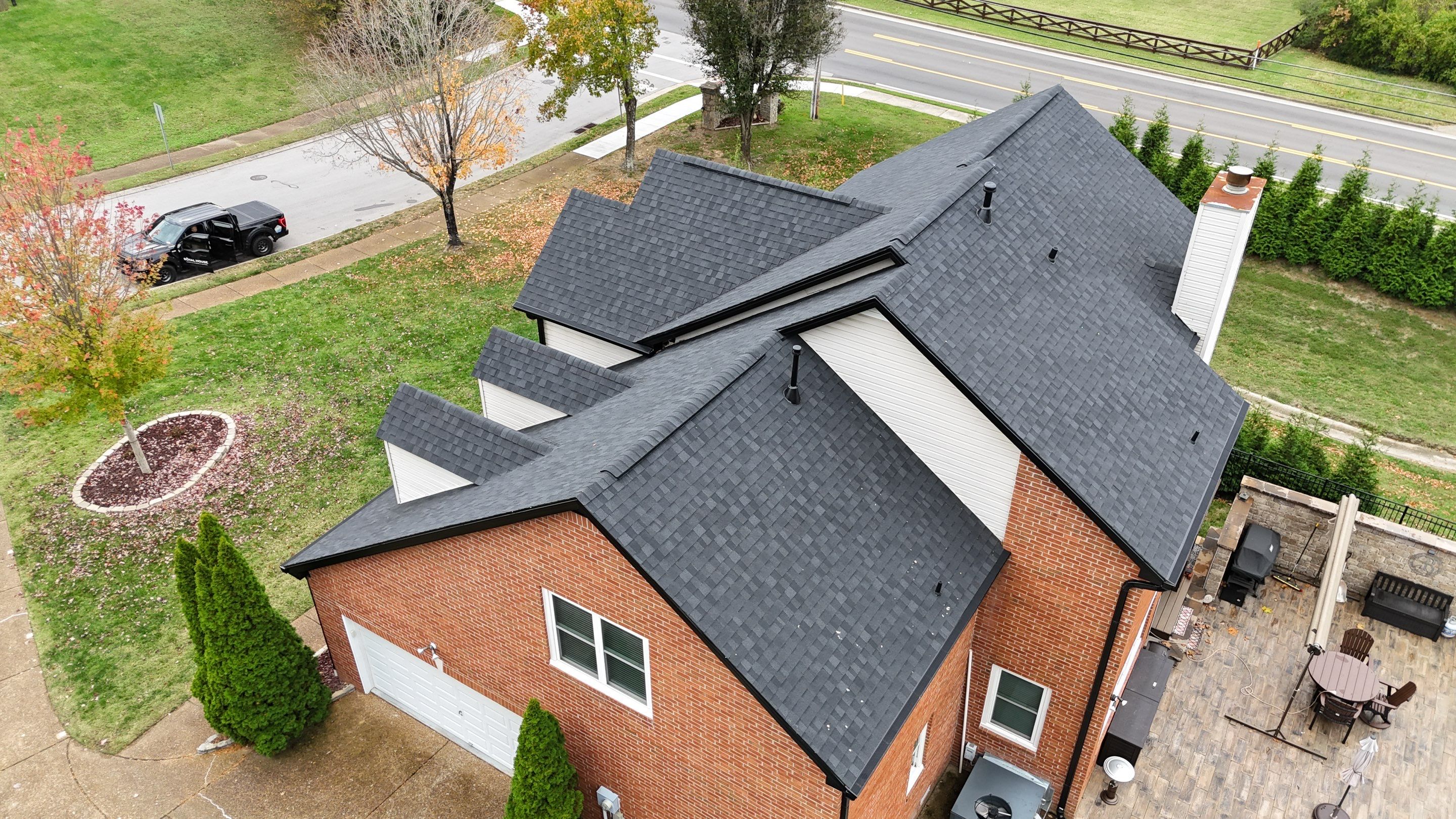 Charcoal Black Re-Roof & Gutters by Royal House LLC