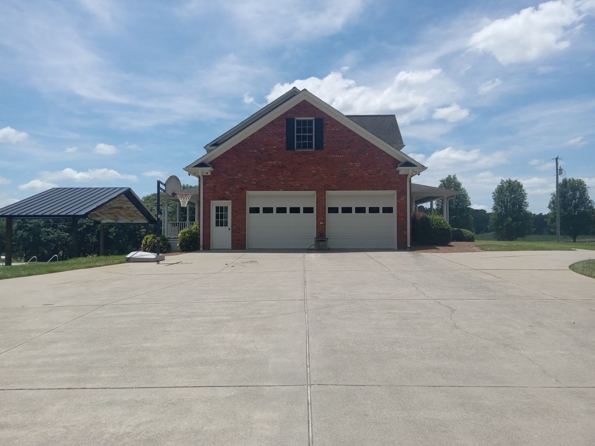 pressure washing driveway and concrete surfaces to remove dirt grime and stains restoring clean appearance