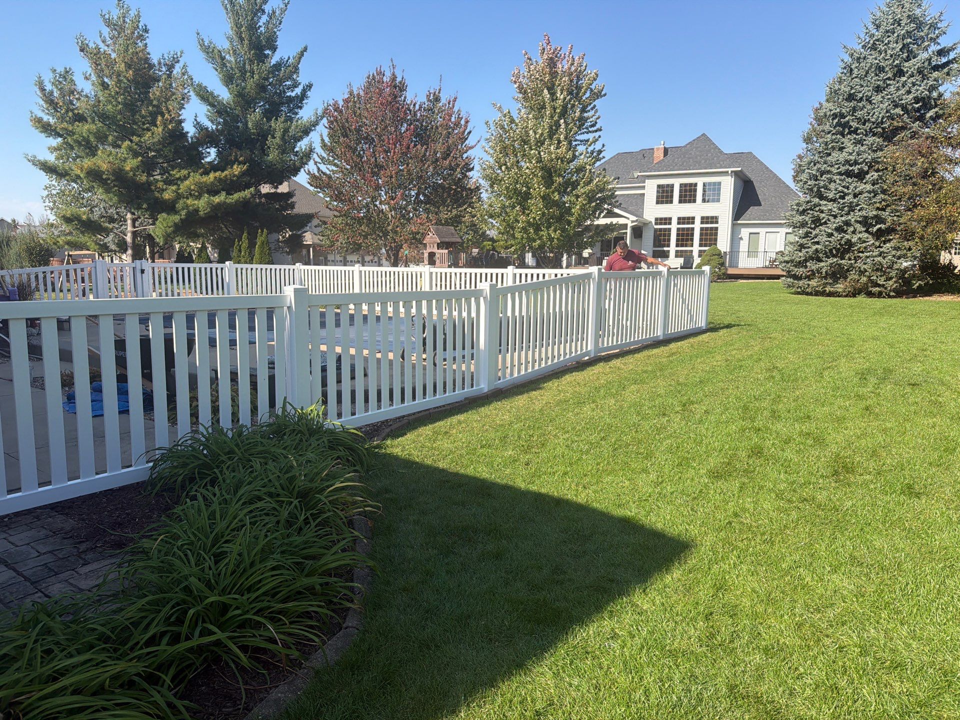White Vinyl Picket Pool Fence Installation in Waterloo, Iowa by Perfect Picket Fence and Stain