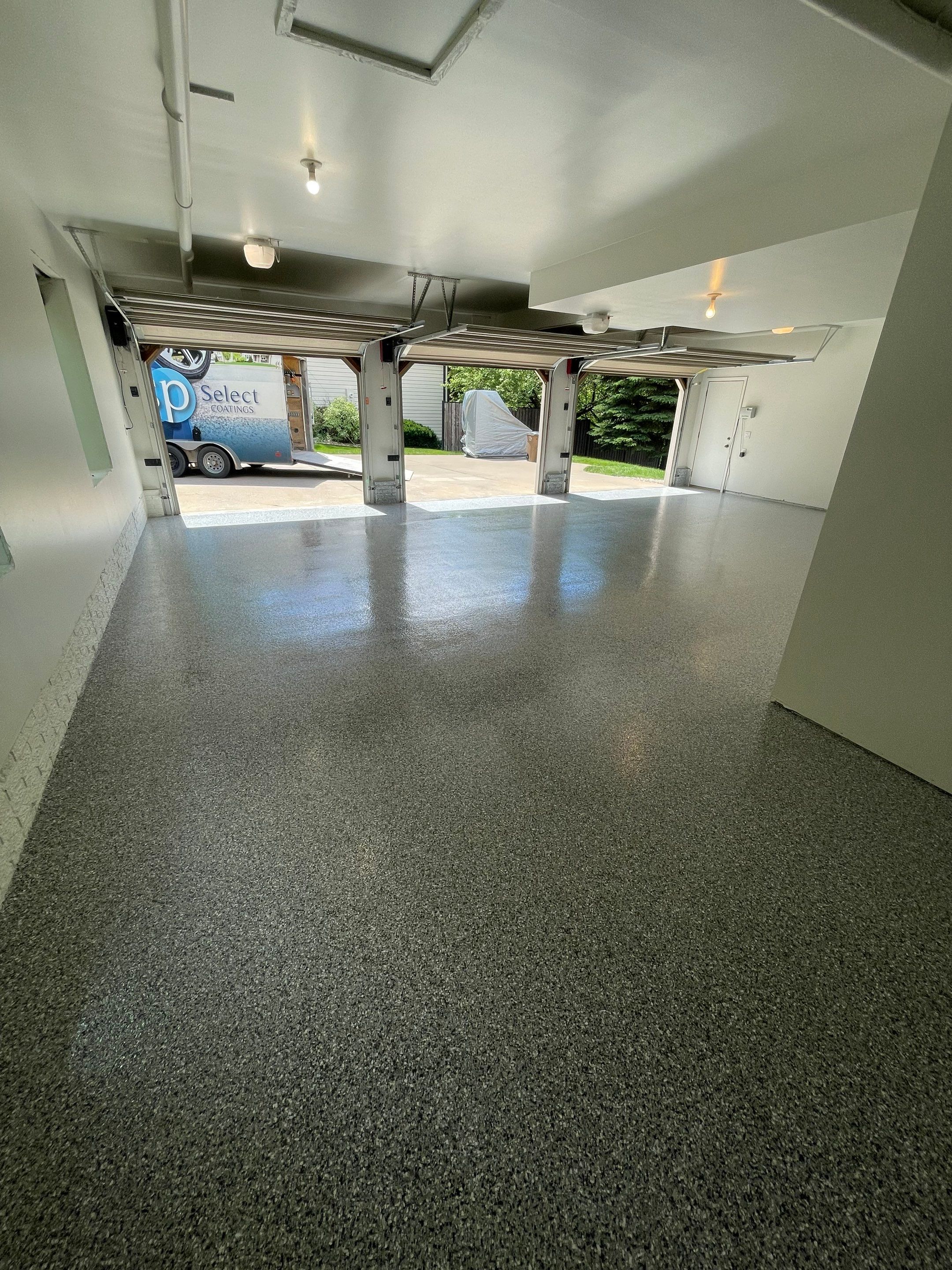 Gray Speckled Epoxy Garage Floor Coating in Sioux Falls by Select Painting, Coatings & Garage Cabinets