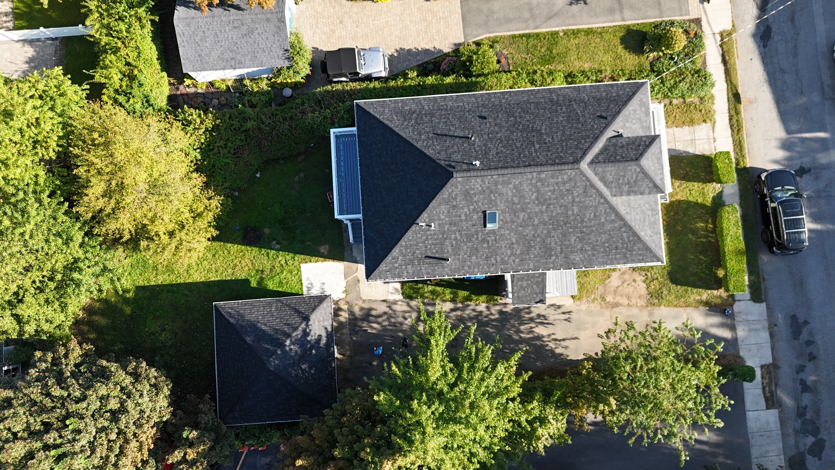 Roof Replacement with Skylight Flashing in Waltham, MA by Mighty Dog Roofing of Greater Middlesex County
