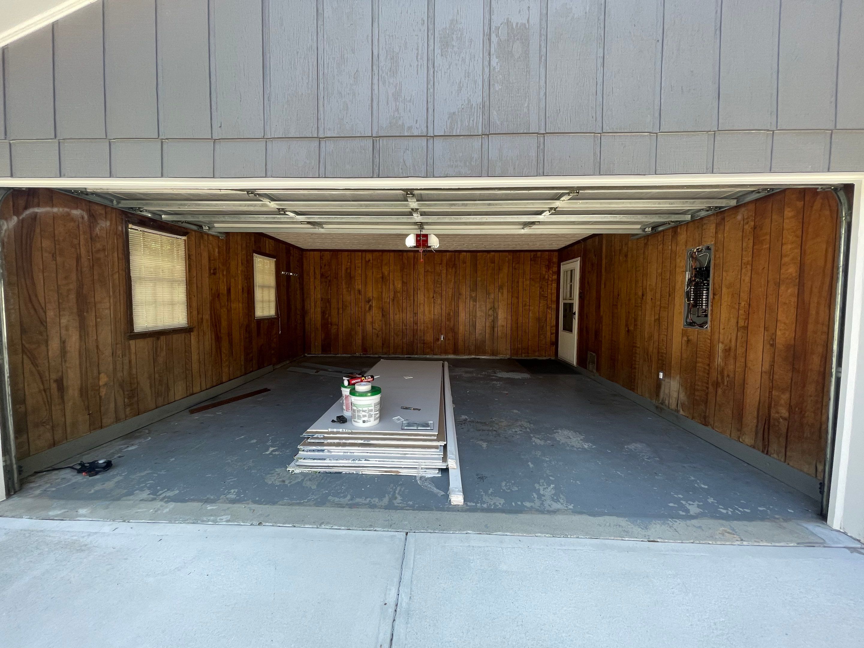 Snellville Garage Remodel Featuring Epoxy Floors and Board and Batten Siding by Swift Home Renovations