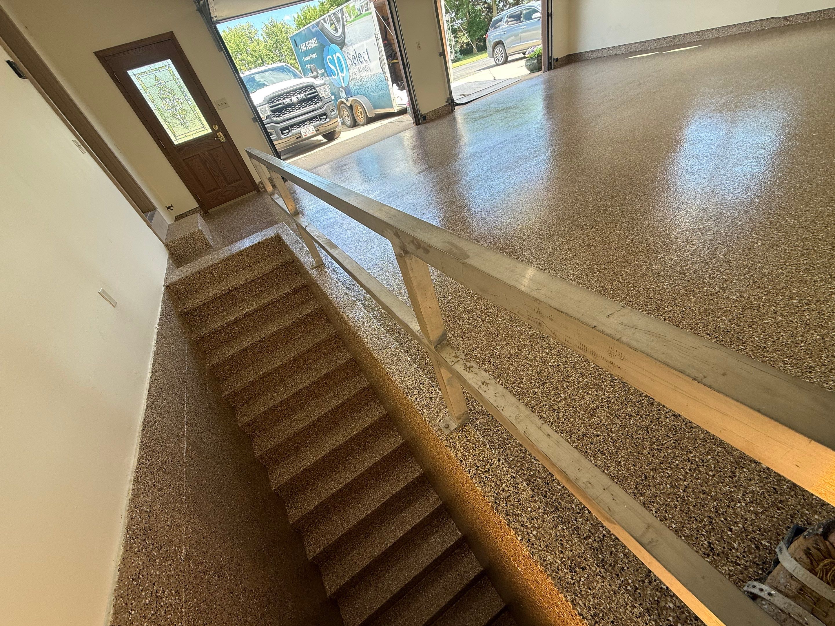 Custom Polyaspartic Garage Floor and Stairwell Coating in Pipestone by Select Painting, Coatings & Garage Cabinets