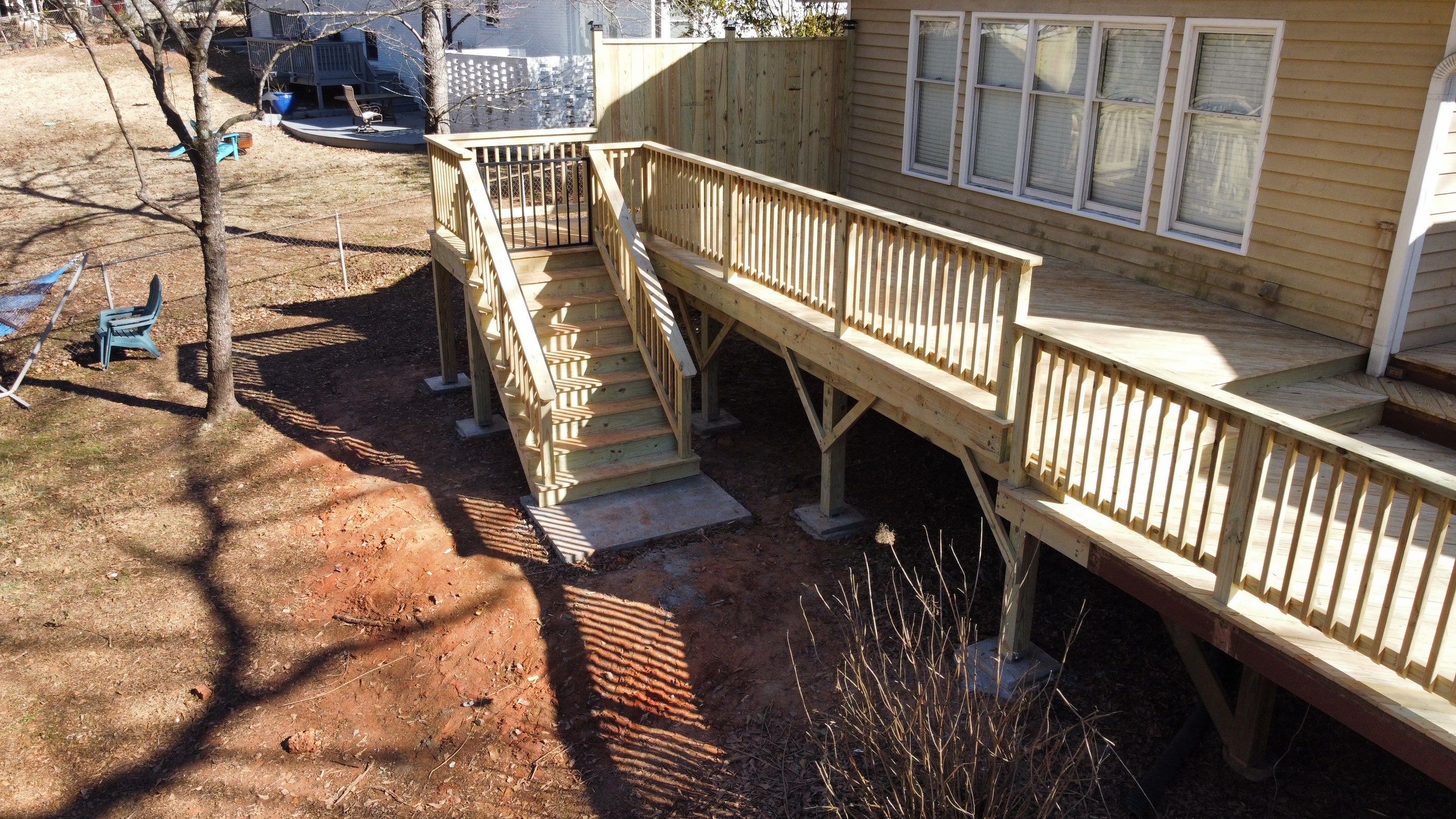 Elevated Pressure-Treated Wood Deck Extension in Marietta by Swift Home Renovations