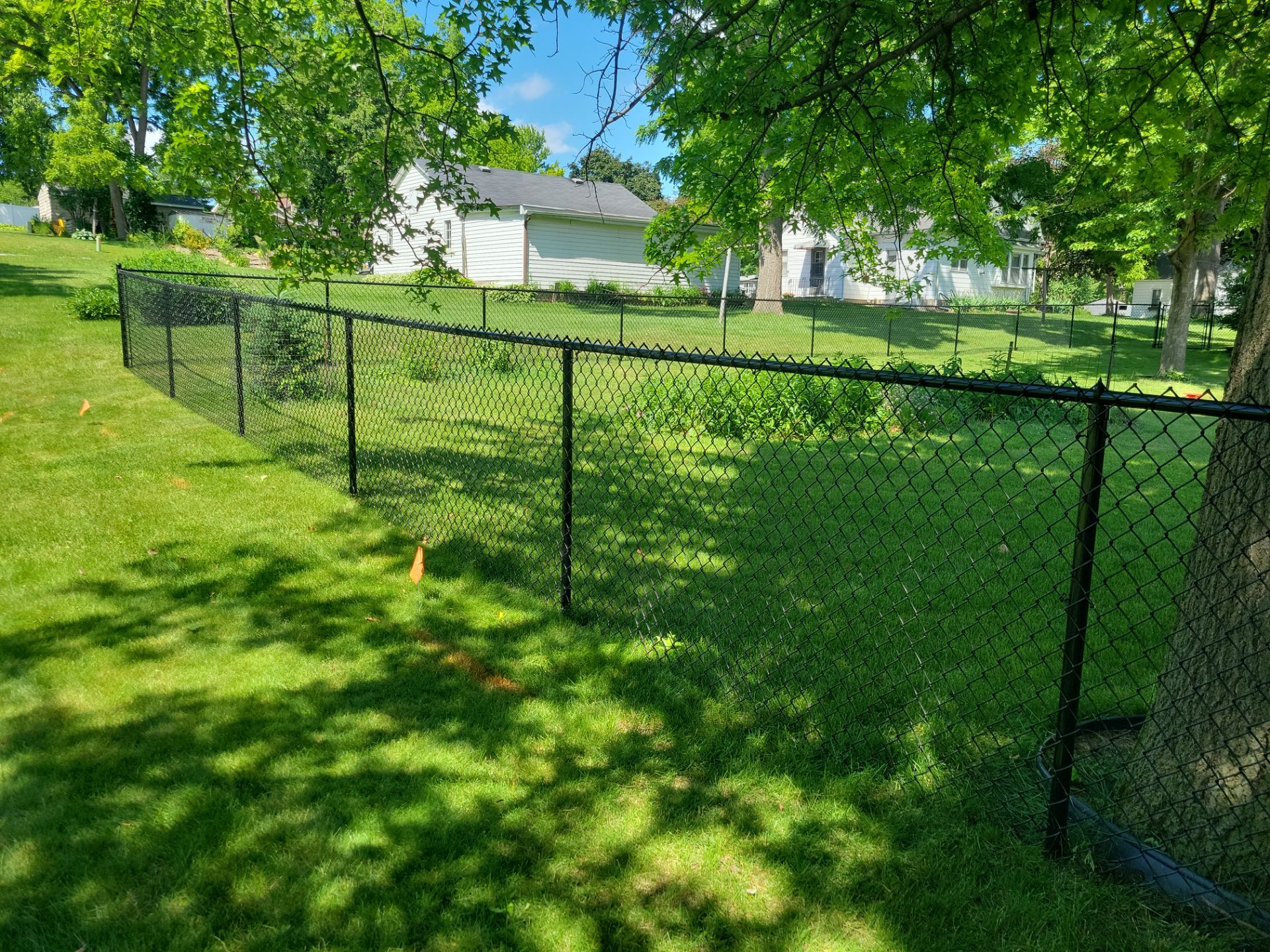 Black Chain Link Perimeter Fence and Driveway Gate in Waverly by Perfect Picket Fence and Stain