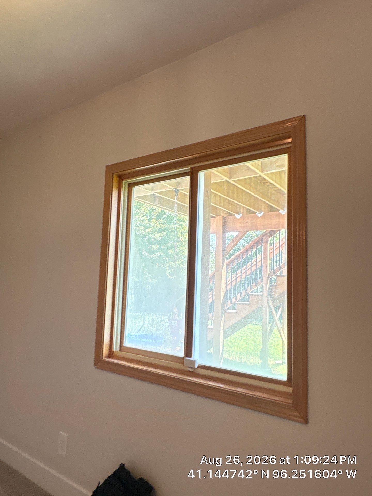 Residential Sliding Window Installation With Natural Wood Trim by CompanyCam Sales Demo