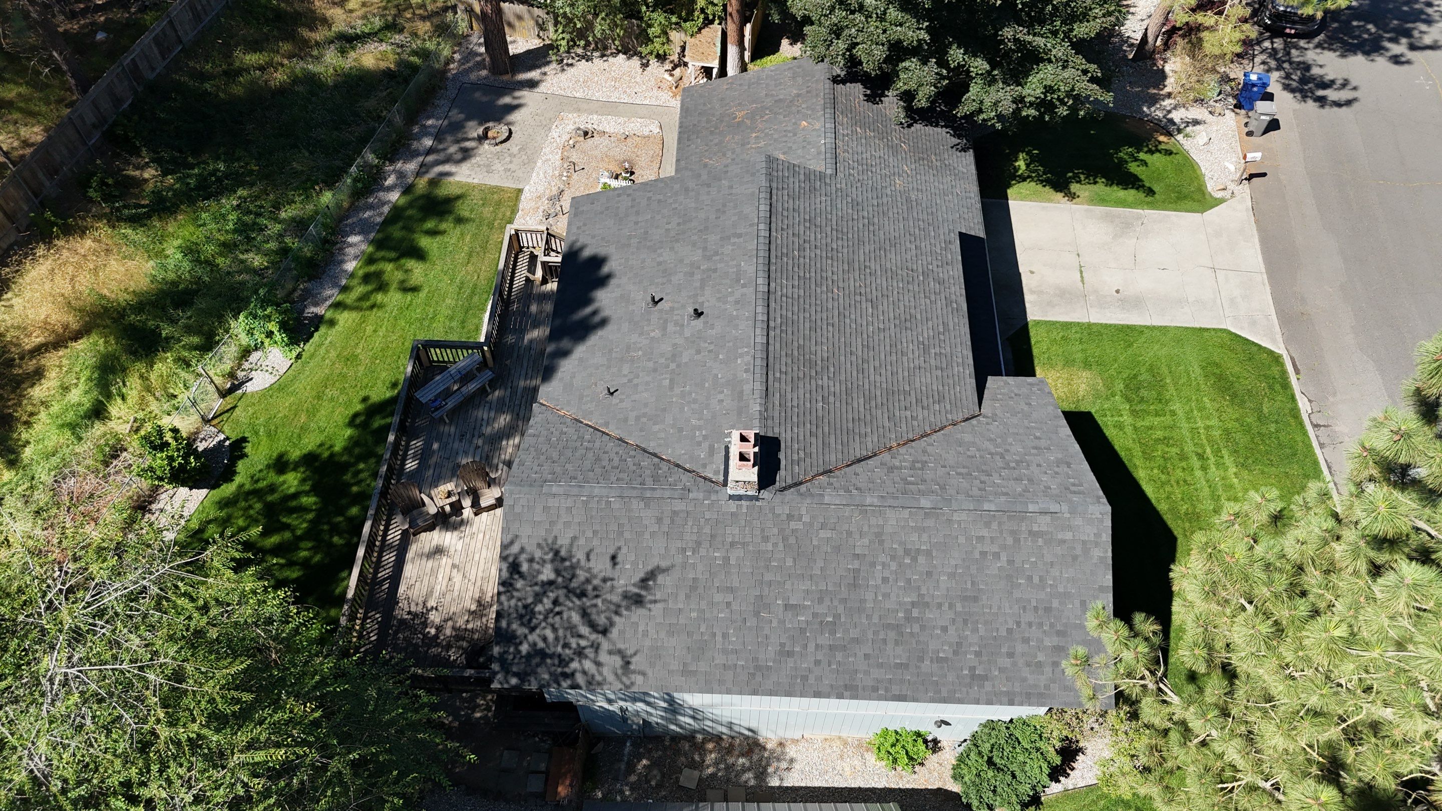 New CertainTeed Landmark TL Moire Black roof installed on Eastview Drive, Spokane, WA by Alpine Roofing.  Shows a completed roof project with clean lines and professional installation.