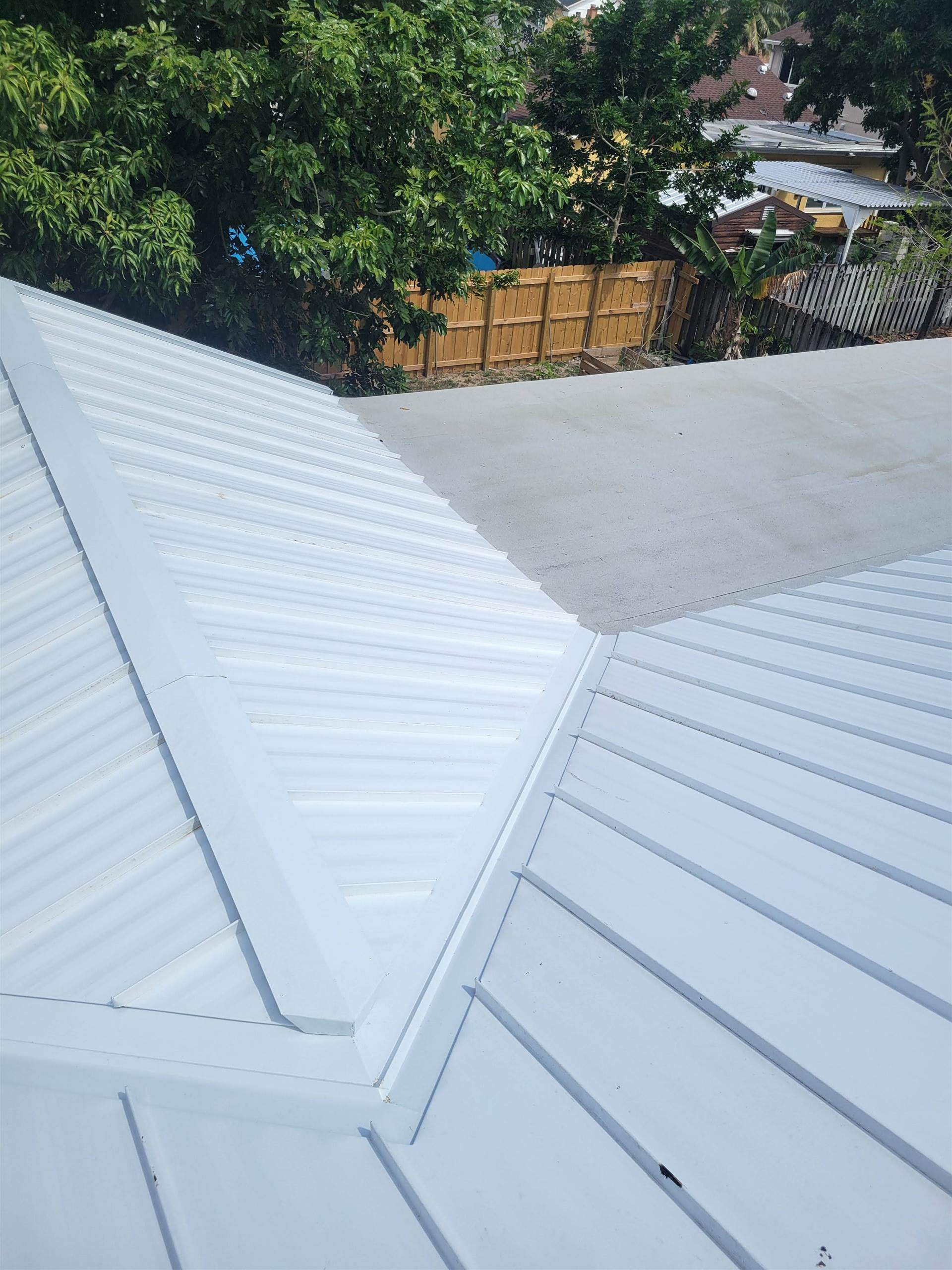 Standing Seam Metal & Flat Re-Roof using 1.5" Nail Strip 24ga Solar White Kynar Coated Standing Seam Metal Panels by Morton Roofing, Inc.