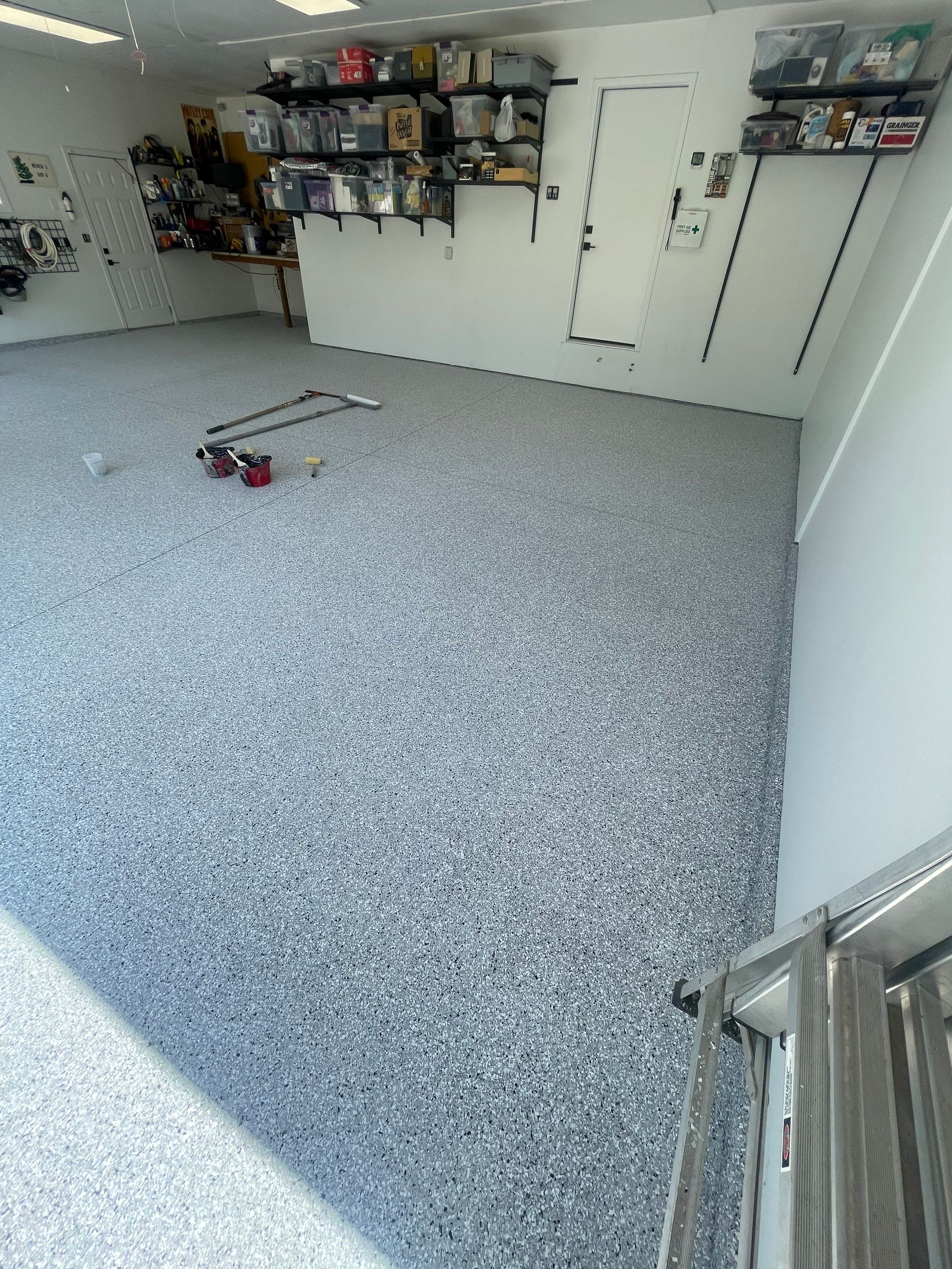 Feather Grey Garage Floor Coating Installation in Sioux Falls by Select Painting, Coatings & Garage Cabinets