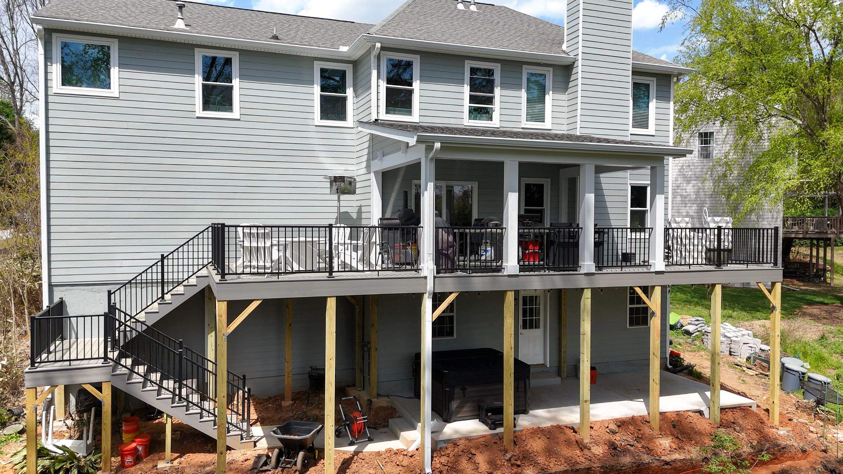 Covered Porch and Deck Build using Deckorators Venture Series Decking and Trex Select Aluminum Railing by Nelson Exteriors