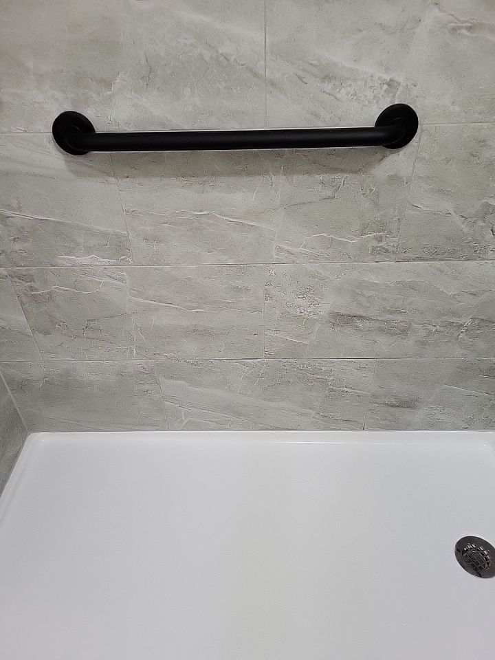 Bathroom Remodel using Tile  by SLM General Contractors & Roofing