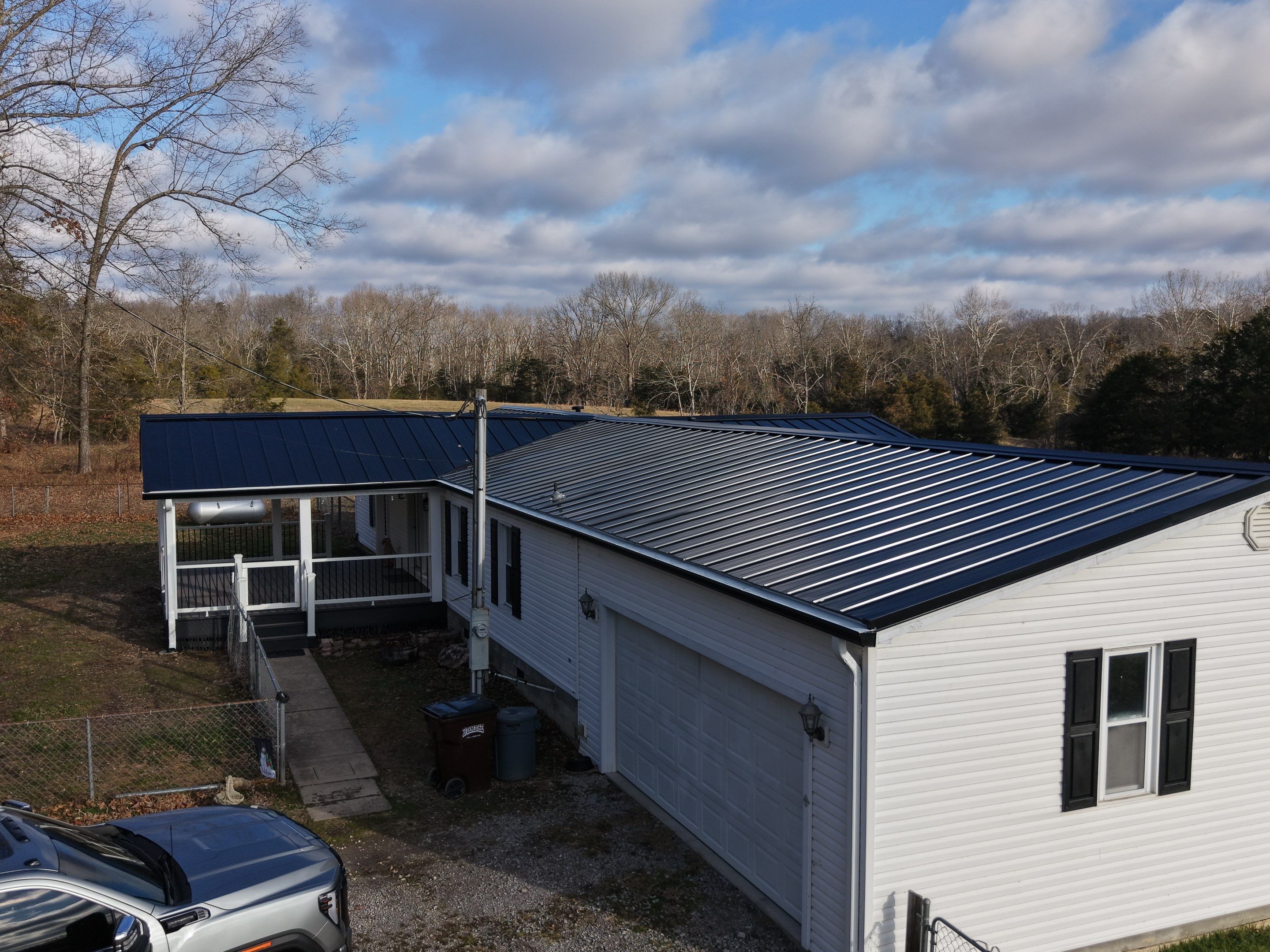 Standing Seam Roof & Black Gutters by Stout Exteriors