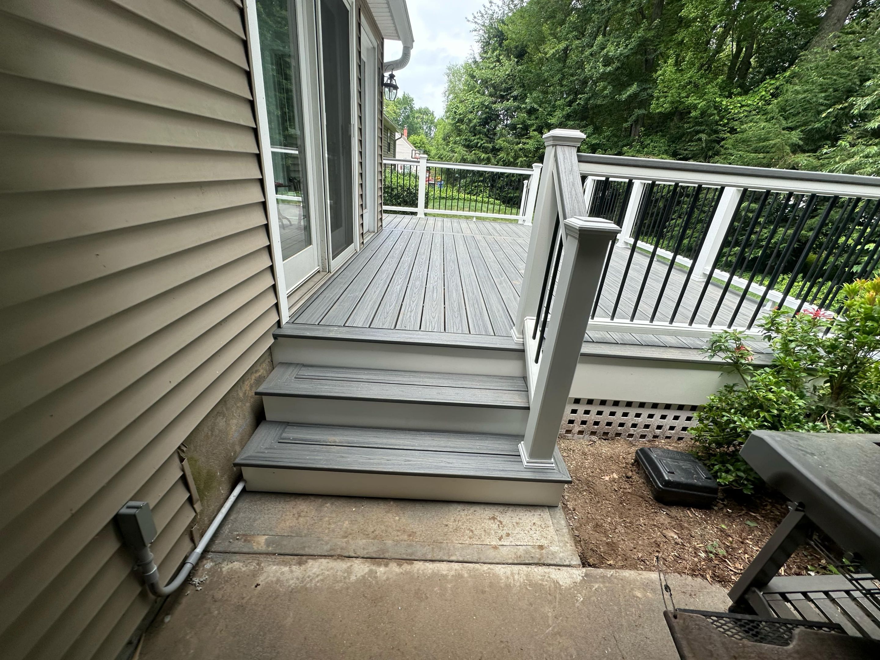 Deck Replacement with Trex Tropical Island Mist , matching cocktail rail and lattice bottom by DiGiorgi Roofing and Siding Inc