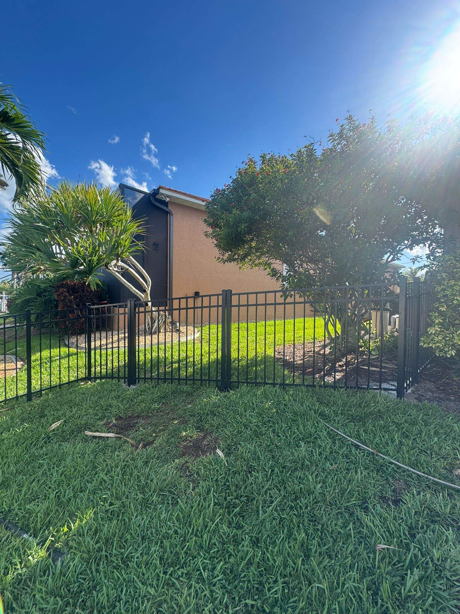 Black Aluminum Fence Installation Along Punta Gorda Canal by True Fence LLC