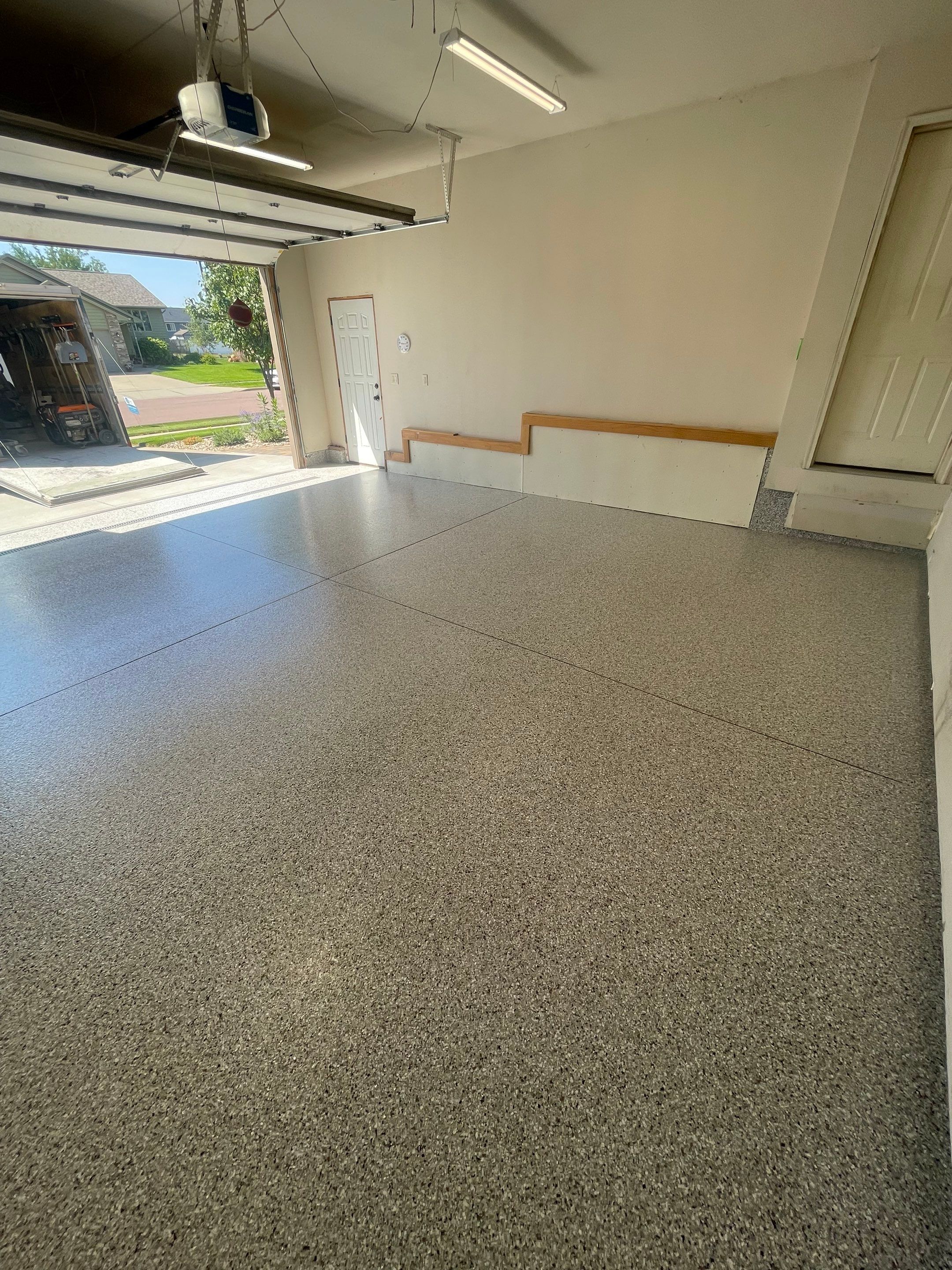 Multi-Stall Garage Floor Coating Installation in Sioux Falls by Select Painting, Coatings & Garage Cabinets