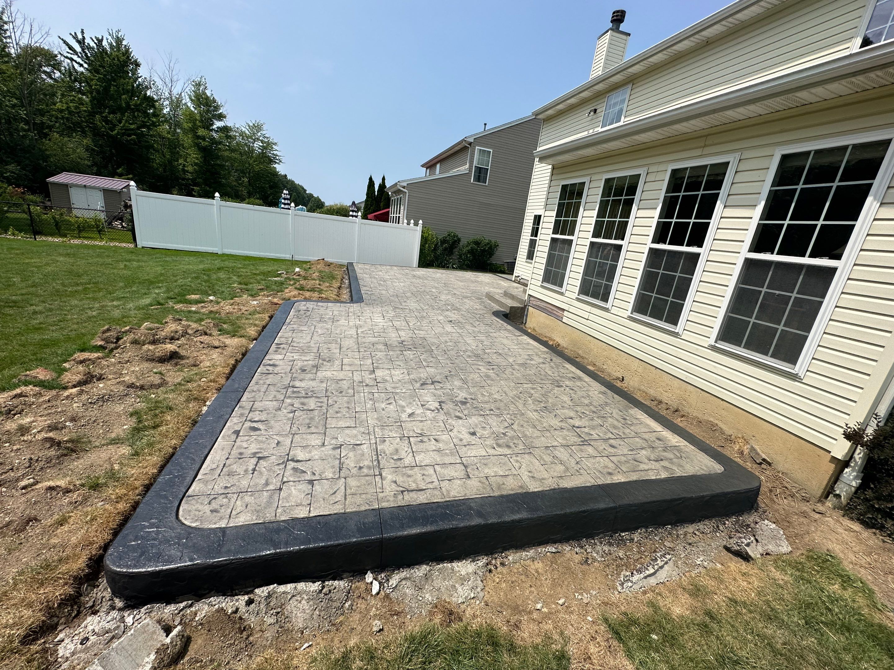Stamped Concrete, Entry Door, and Concrete  by Ivy Lea Construction