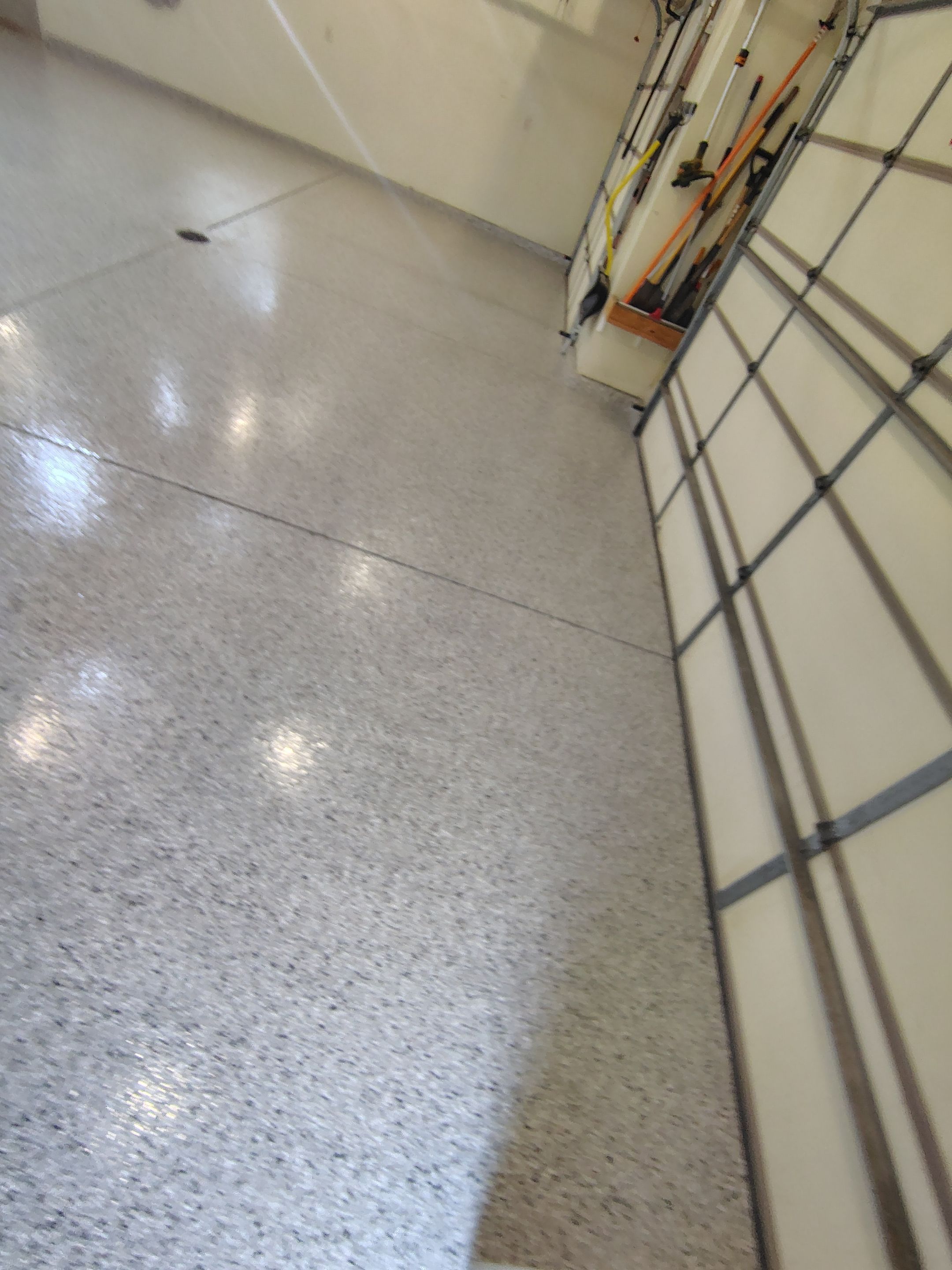 Sioux Falls Garage Floor Repair and Speckled Epoxy Coating Installation by Select Painting, Coatings & Garage Cabinets