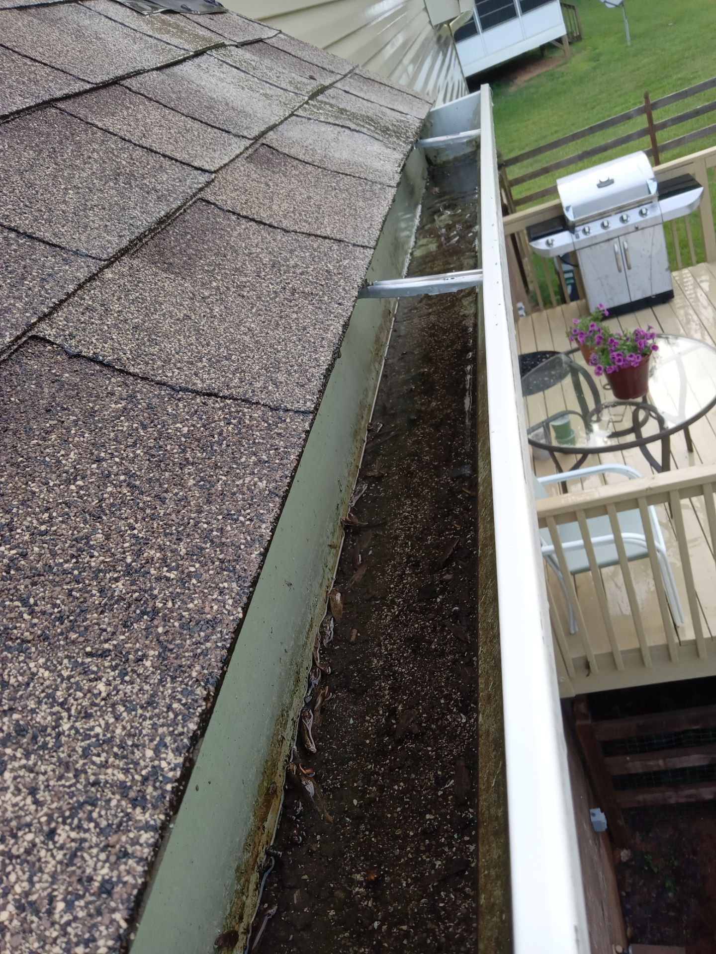 gutter cleaning removing debris and buildup from roof drainage system