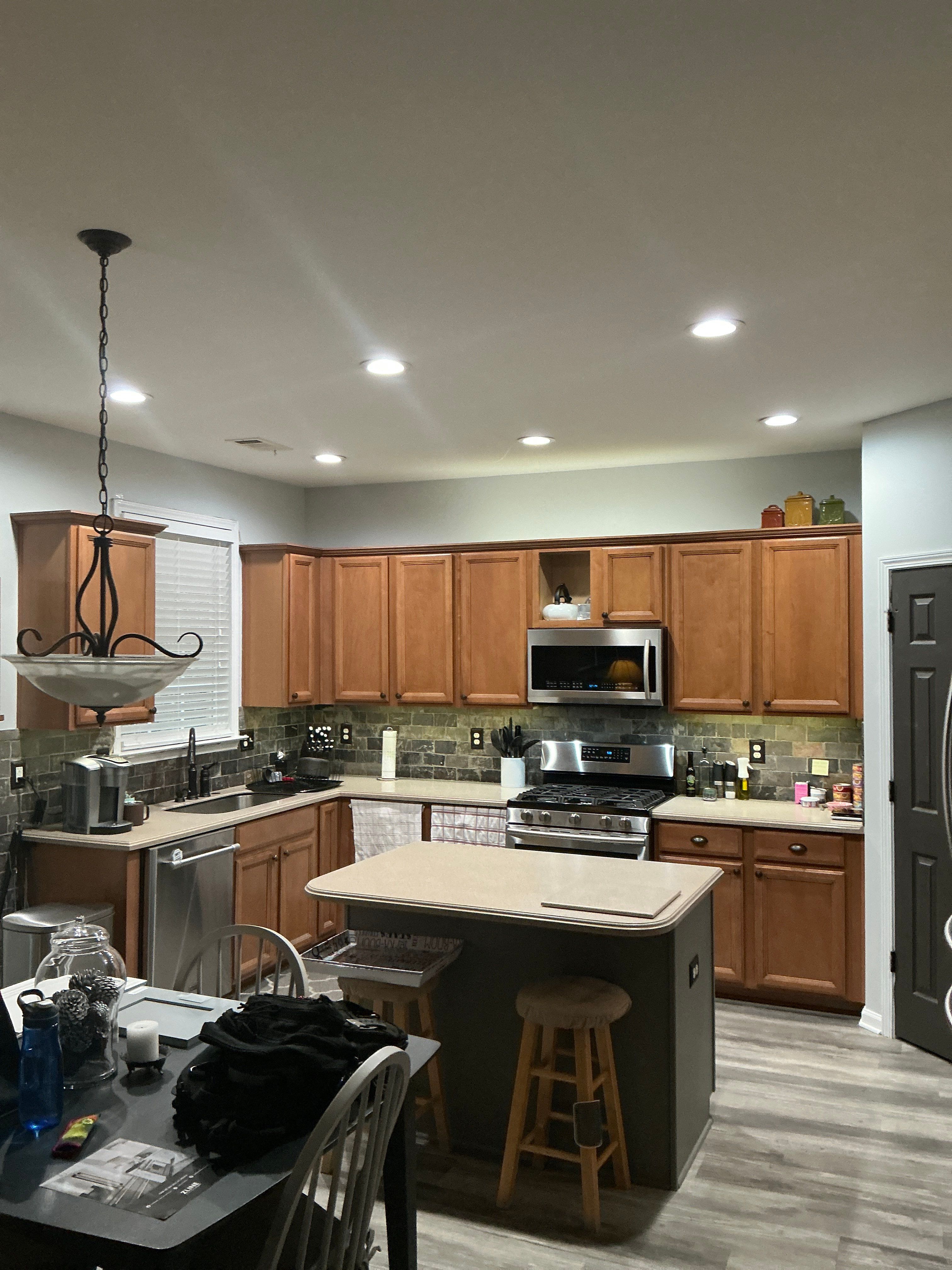 Modern Kitchen Remodel With Grey Shaker Cabinets and Navy Blue Island by Heart & Home Kitchen & Bath Remodeling LLC
