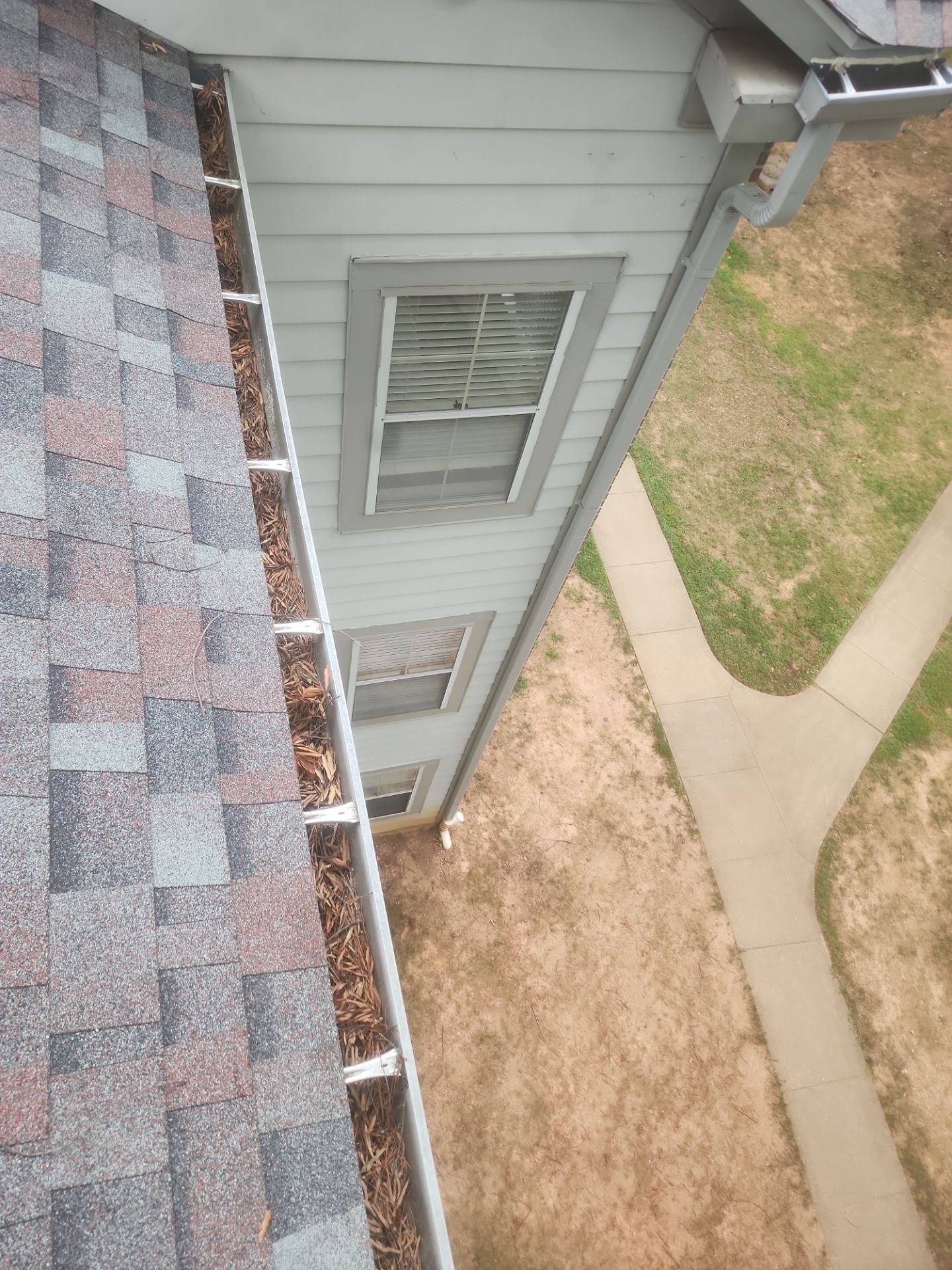 Commercial gutter cleaning Rockville & Bethesda, MD before photo with filled gutters