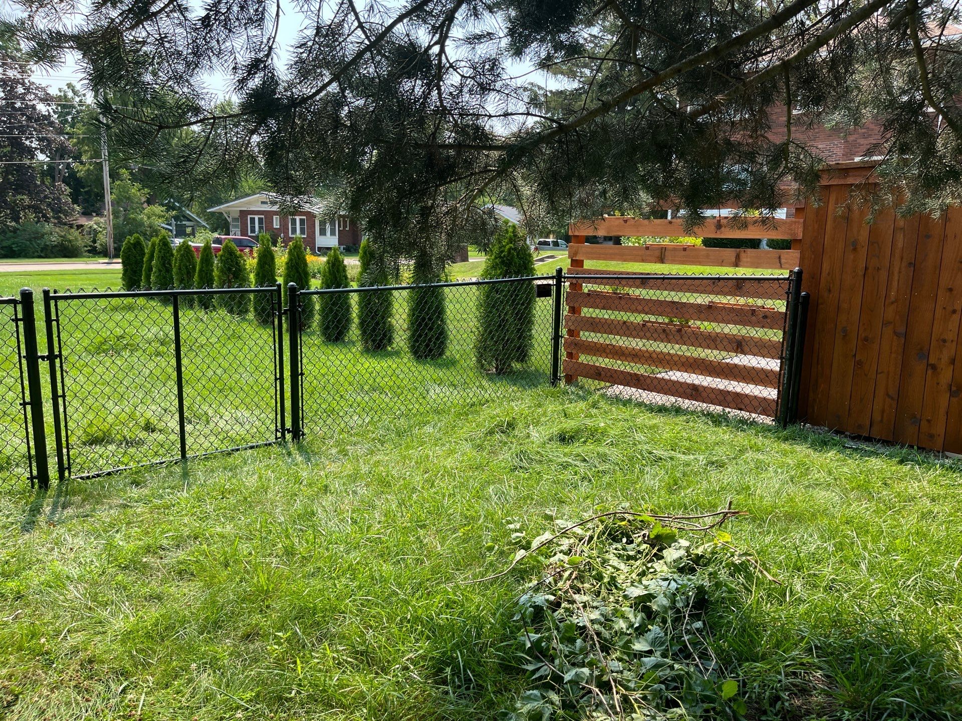 Residential Black Chain Link Fence Installation in Cedar Falls by Perfect Picket Fence and Stain