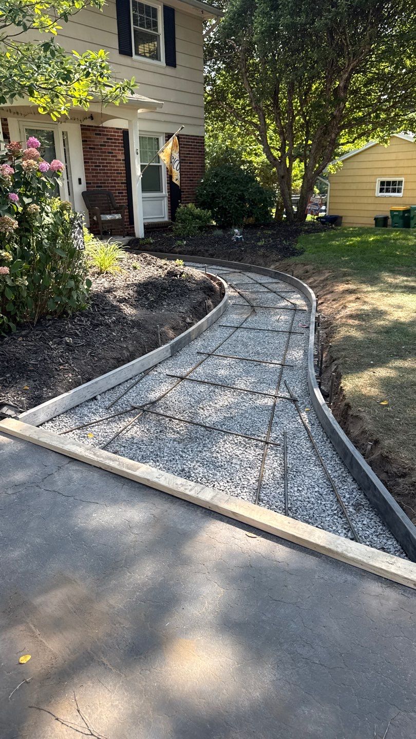 Broom finished concrete patio and sidewalk  by NG Masonry & Construction LLC