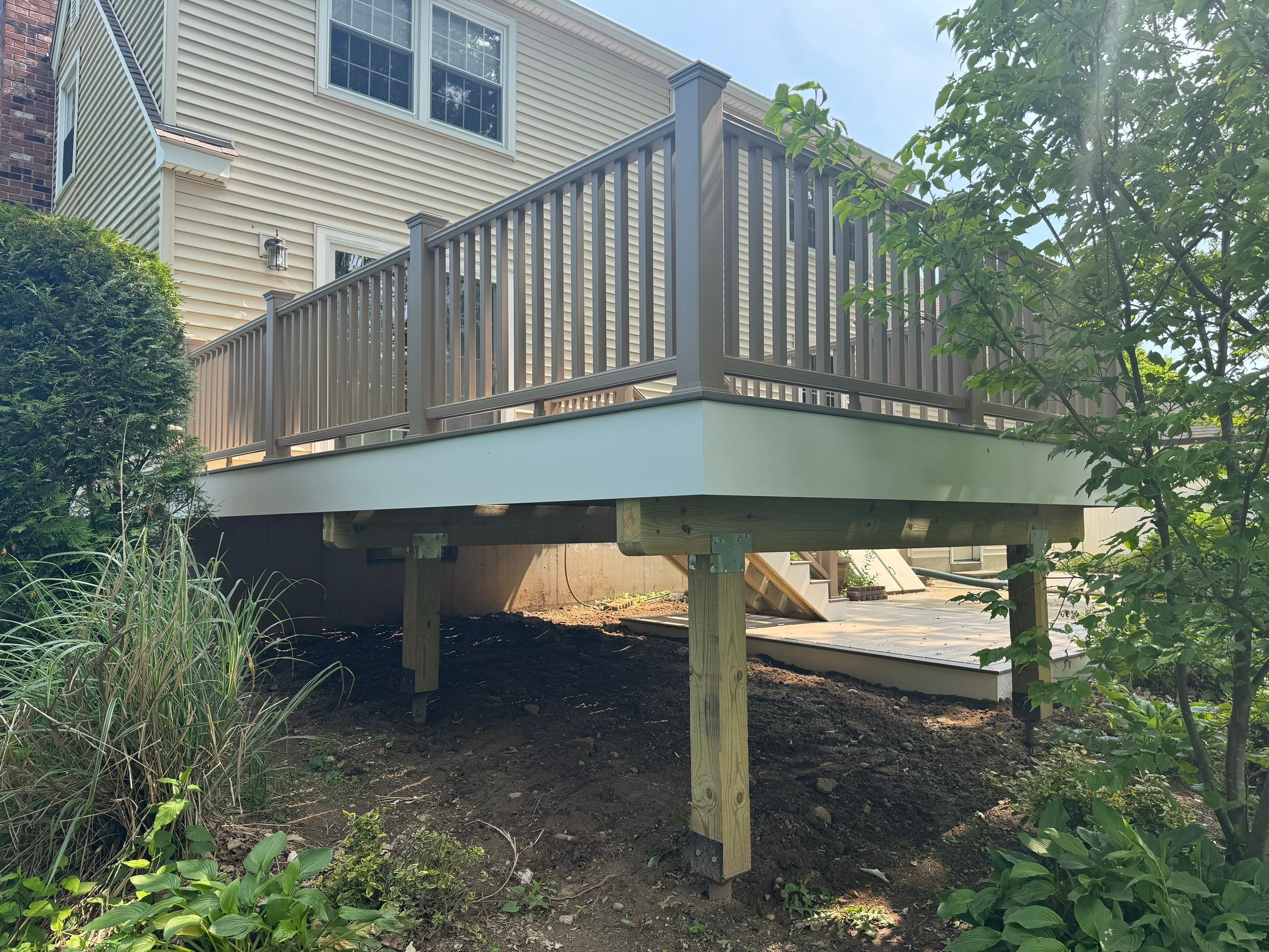Deck replacement using Trex Transcend Rope Swing and Matching Rope Swing Transcend railing by DiGiorgi Roofing and Siding Inc