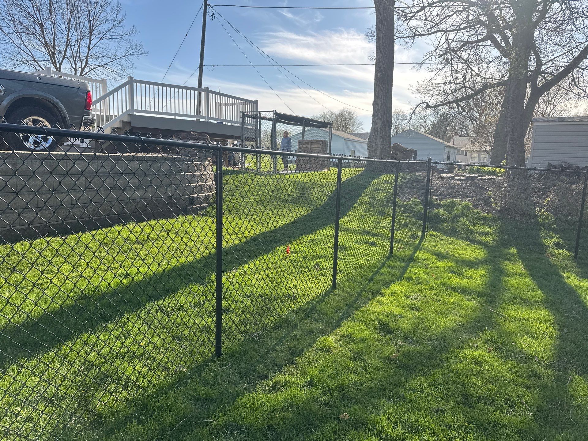 Black Vinyl-Coated Chain Link Fence Installation in Waterloo by Perfect Picket Fence and Stain
