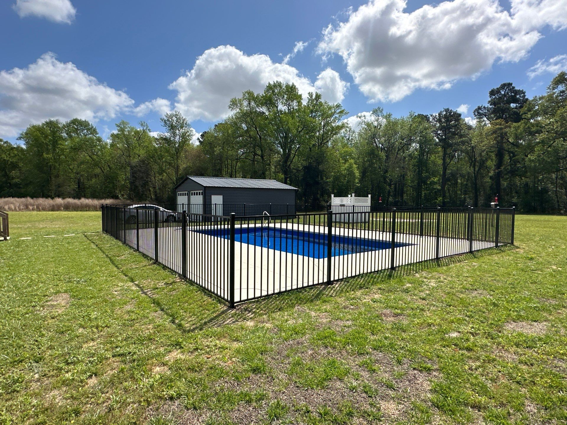 Black Aluminum Pool Fence Installation in Whiteville, NC by Superior Fence and Rail