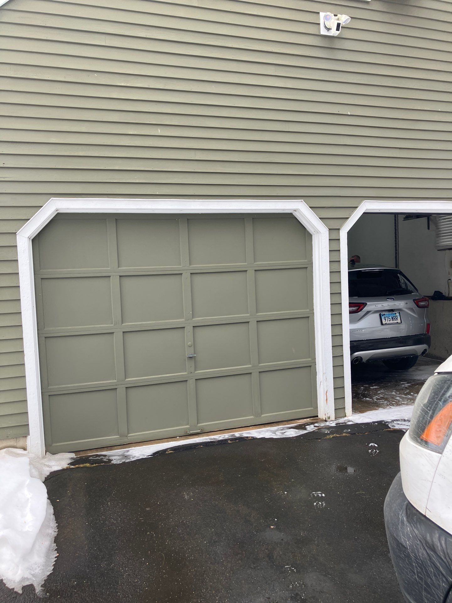 Clean Garage Door Upgrade with Modern Hardware Detail by DiGiorgi Roofing and Siding Inc