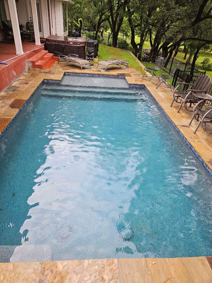 Geometric Pool with Raised Stone Wall and Flagstone Decking by Pinnacle Pools and Spas - DFW