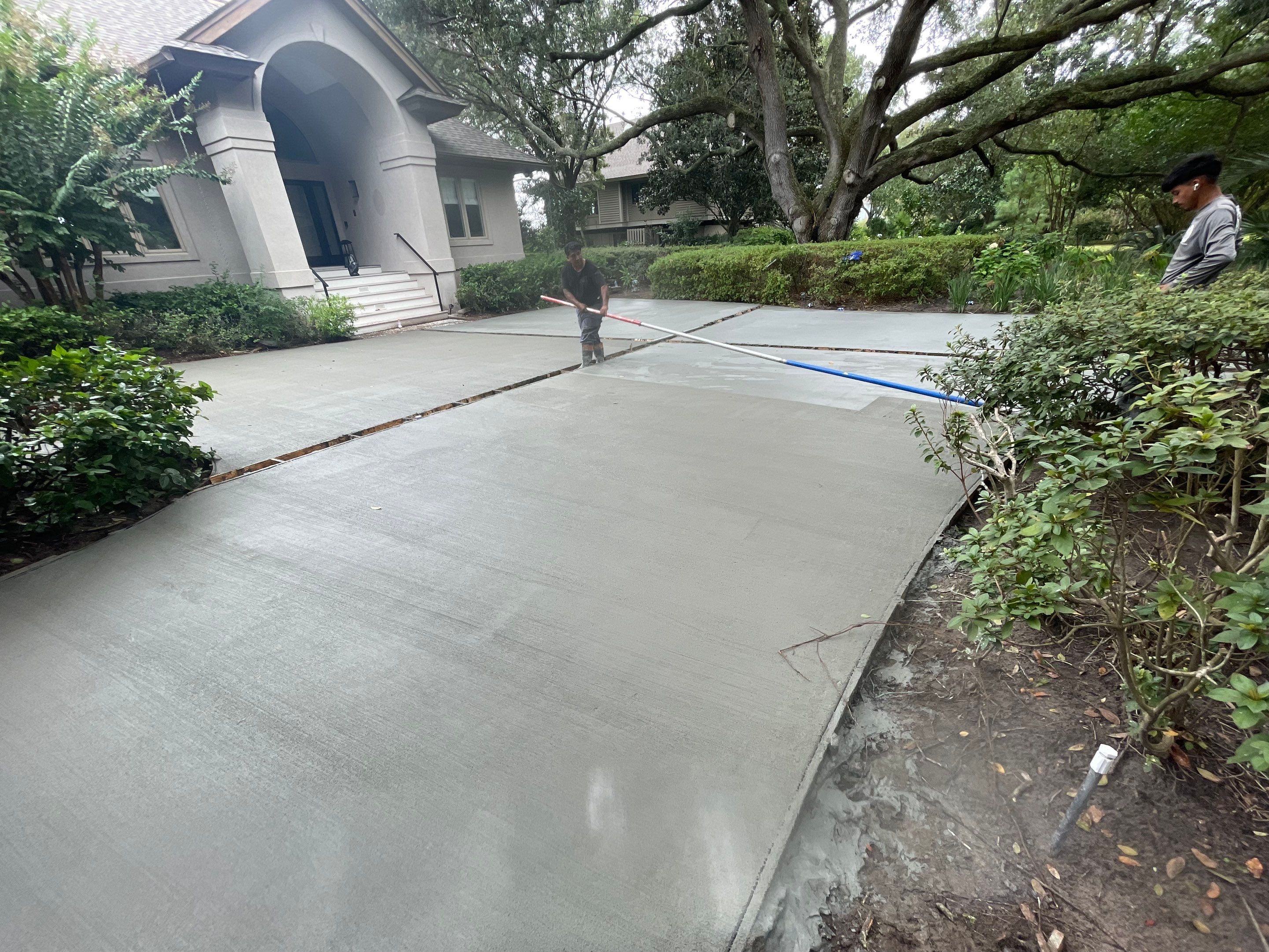 Custom Concrete Driveway with Decorative Paver Inlays in Hilton Head Island by Lowcountry Scapes, LLC