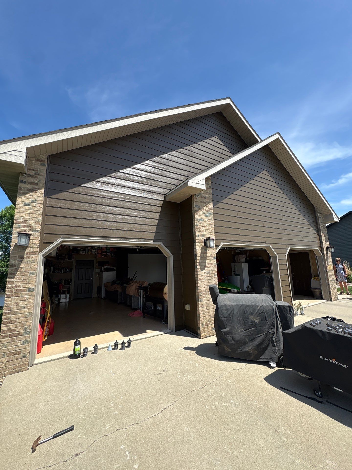 Full Exterior Renovation with Stone Veneer and Composite Decking by Select Painting, Coatings & Garage Cabinets