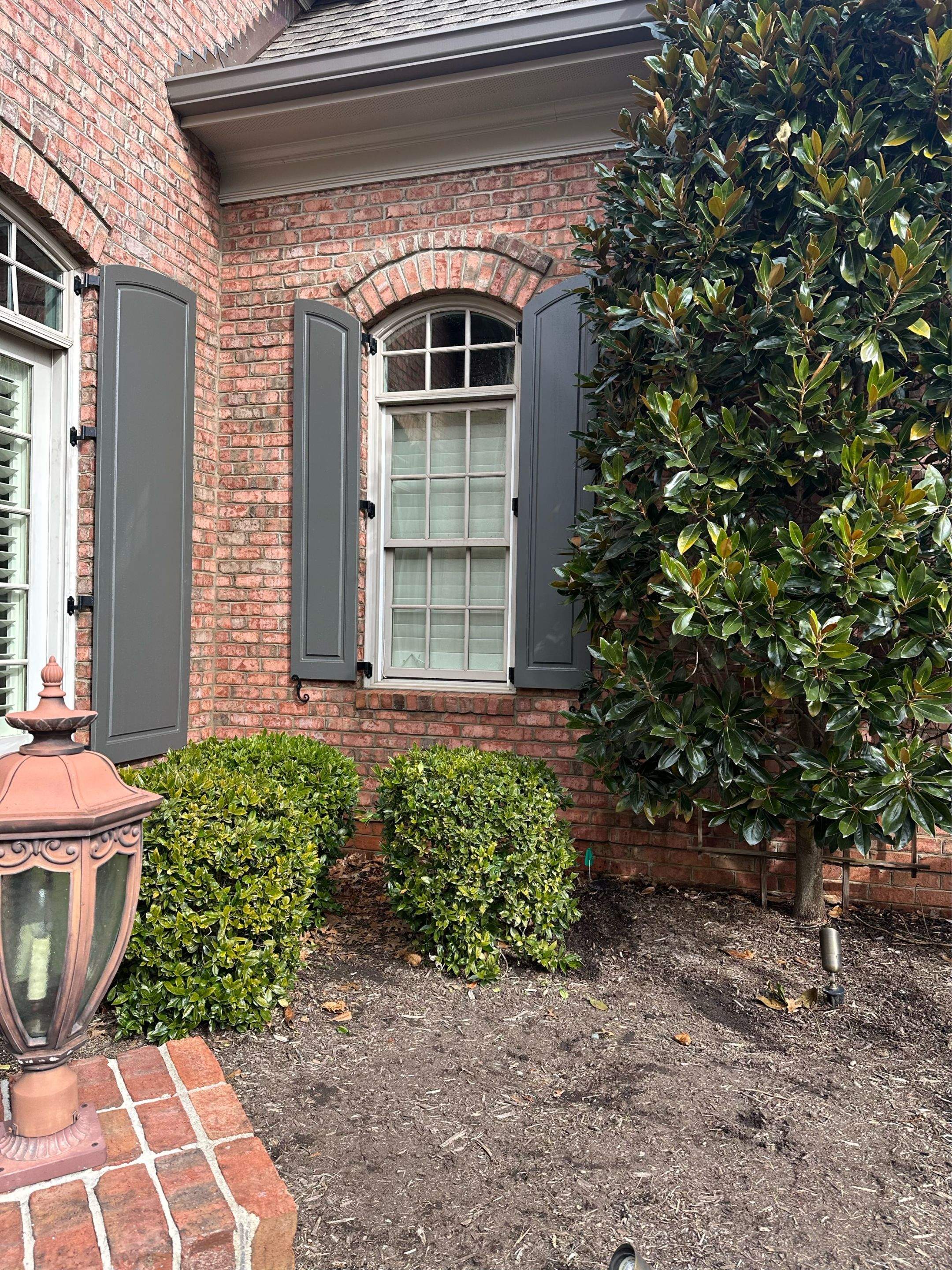 Exterior raised panel shutters by Southern Traditions Window Fashions