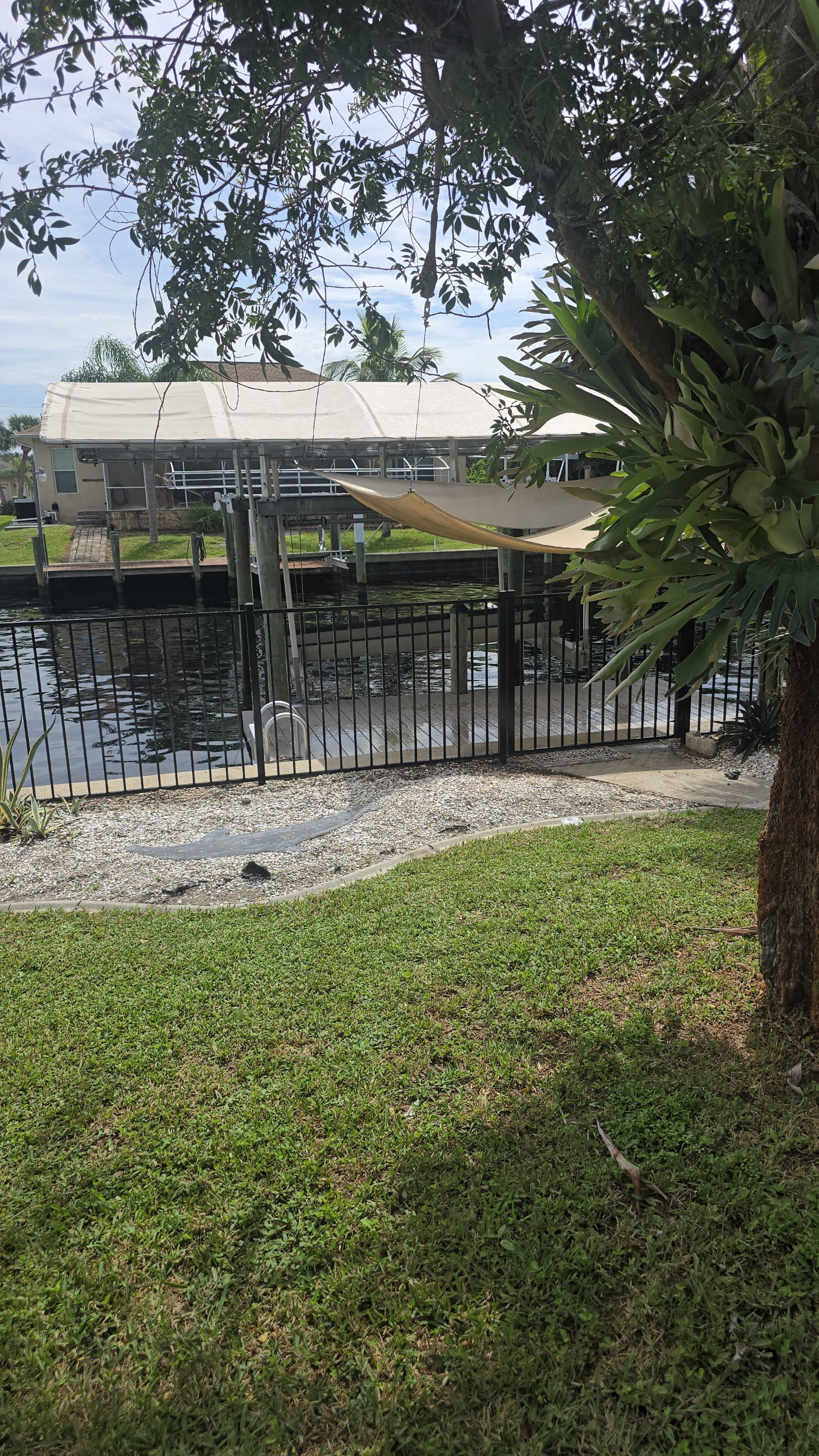 Black Aluminum Picket Fence Installation for Port Charlotte Canal Home by True Fence LLC