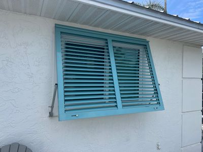 Hurricane Rated Bahama Shutters in Pastel Turquoise