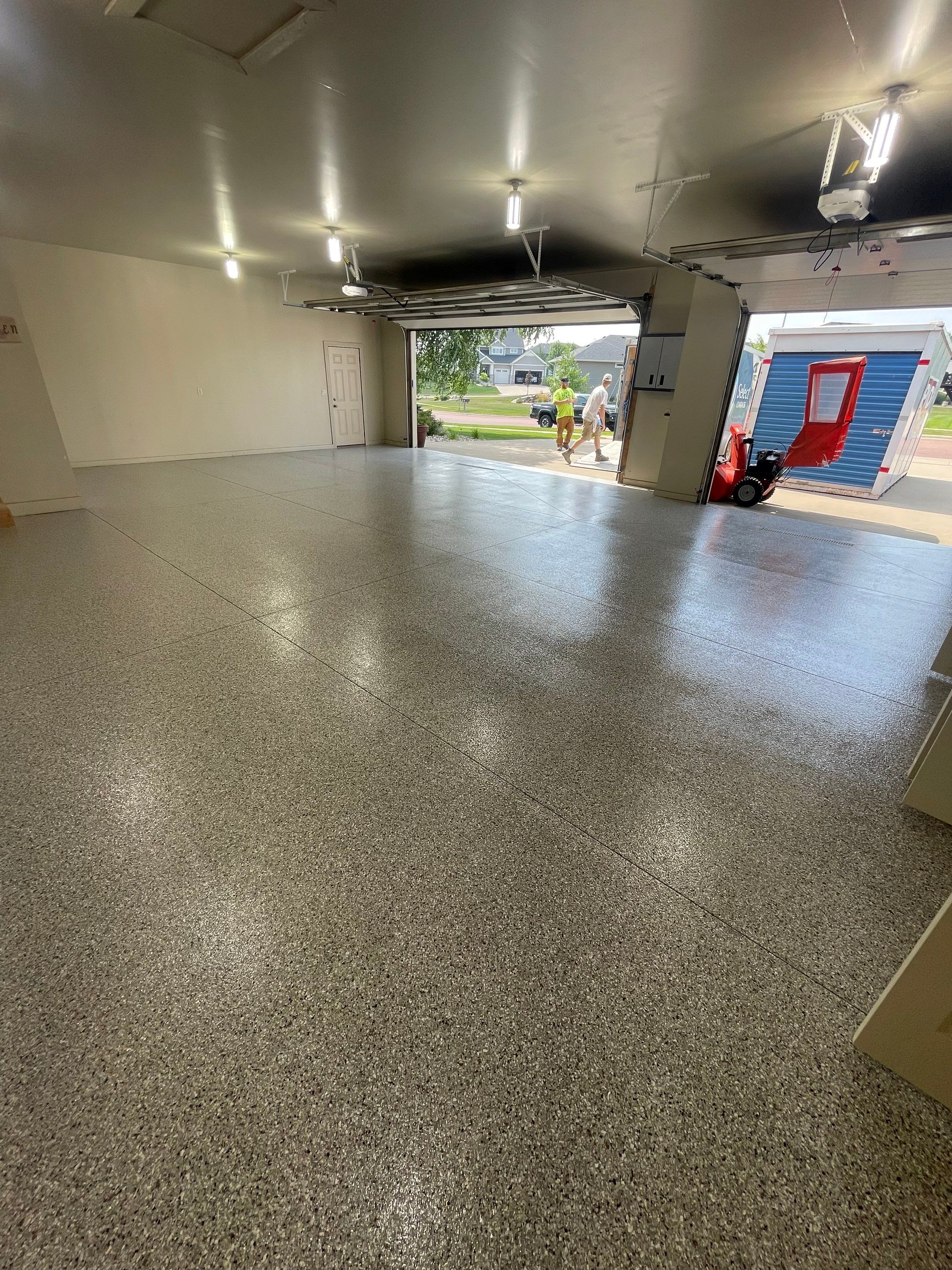Coyote Flake Garage Floor Coating in Sioux Falls with Trench Drain by Select Painting, Coatings & Garage Cabinets
