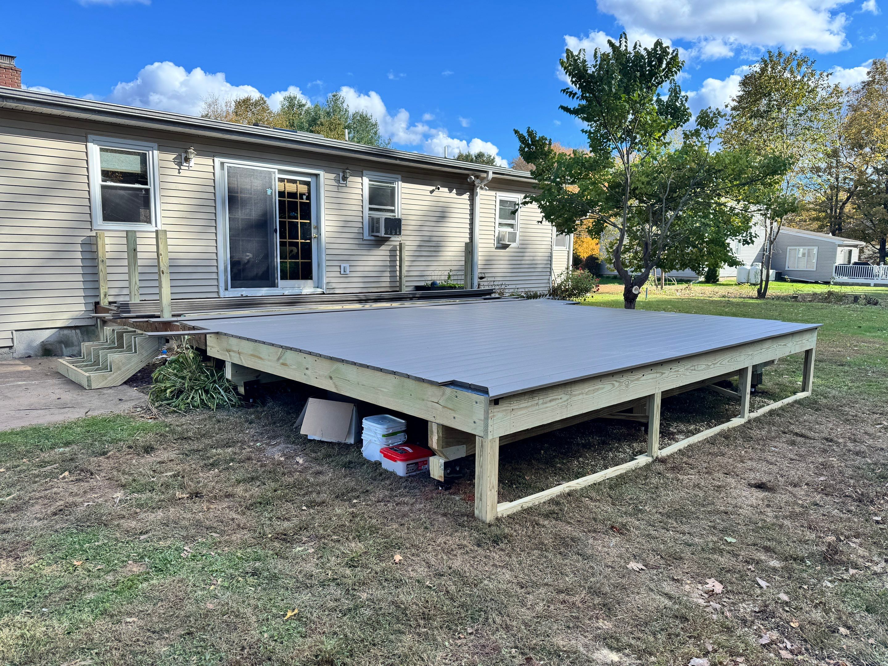 Replacement deck and Roof overhang. Trex Lineage Biscayne boards and matching cocktail rail.  by DiGiorgi Roofing and Siding Inc