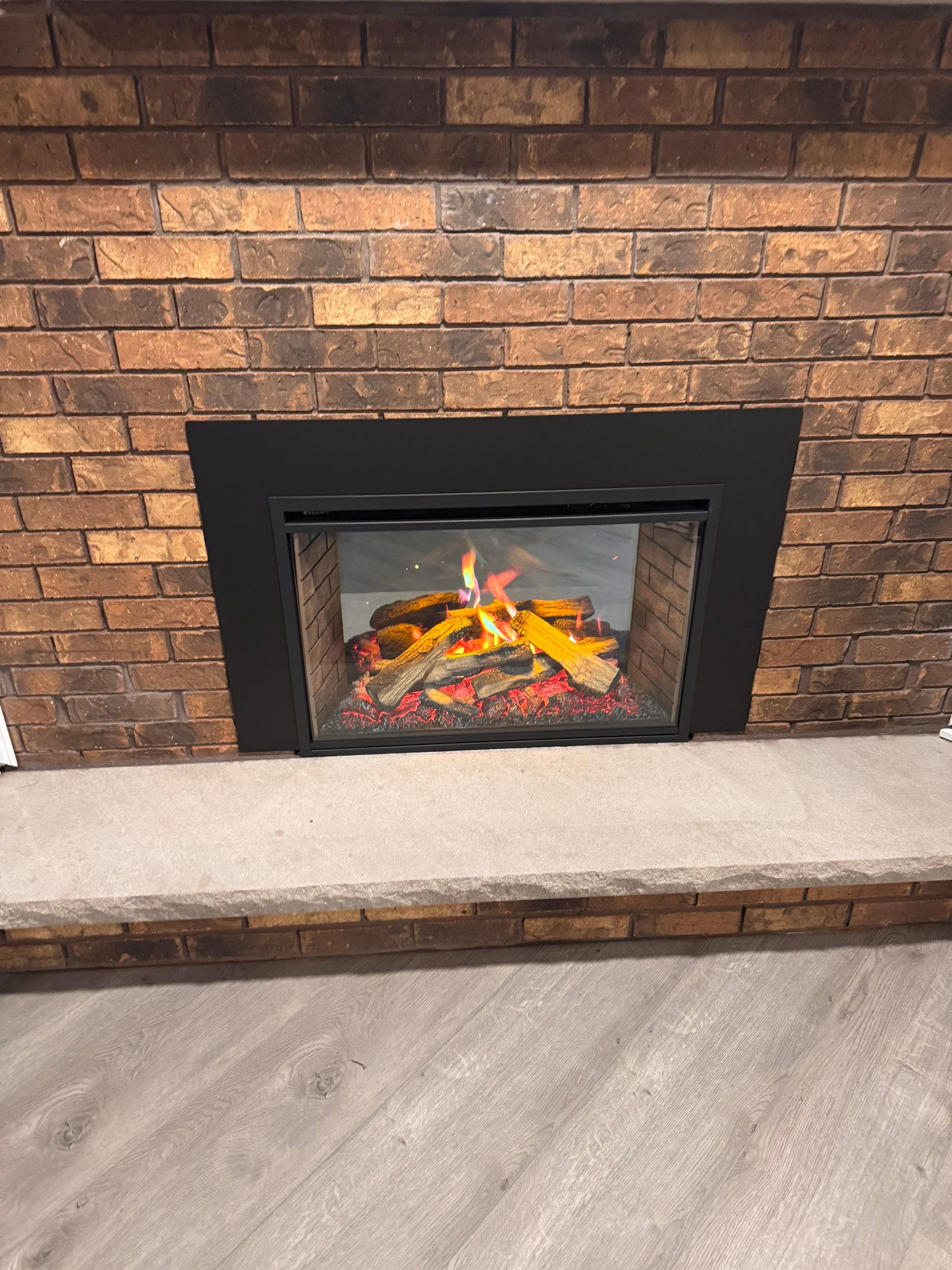Electric Fireplace and Limestone Hearth & Mantel Installation by Leonard and Sons Building Services, Inc.
