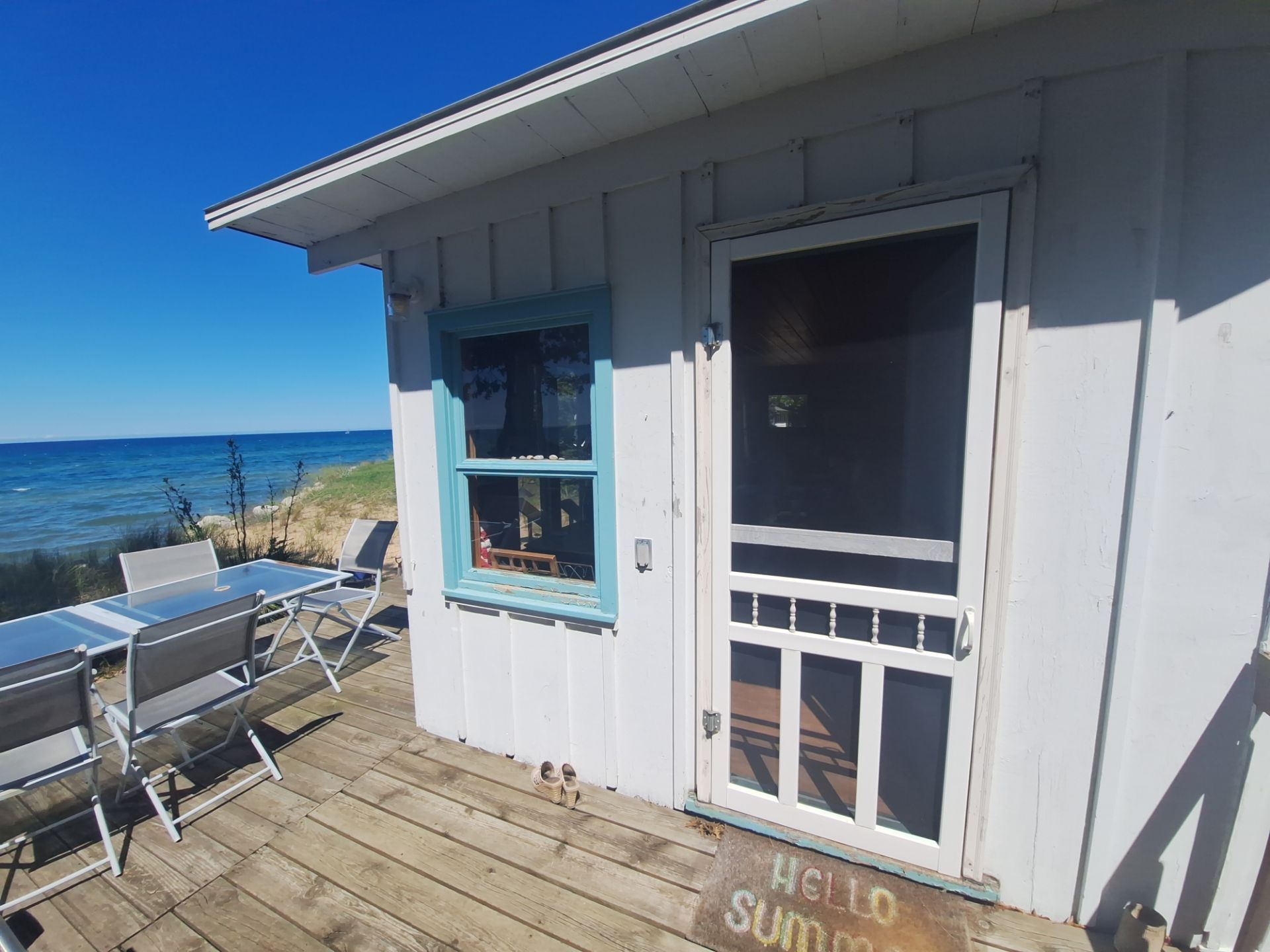 Lakeside Cottage Exterior Painting and Teal Trim Restoration in Mears by Gordon Painting