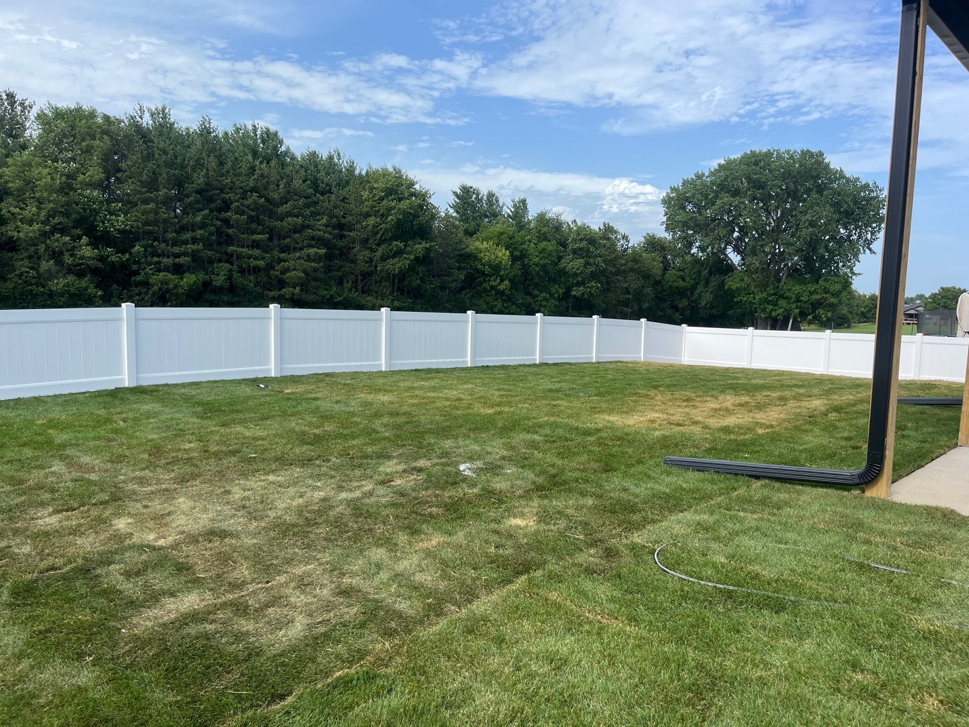 White Vinyl Privacy Fence With Pet Window in Cedar Falls by Perfect Picket Fence and Stain